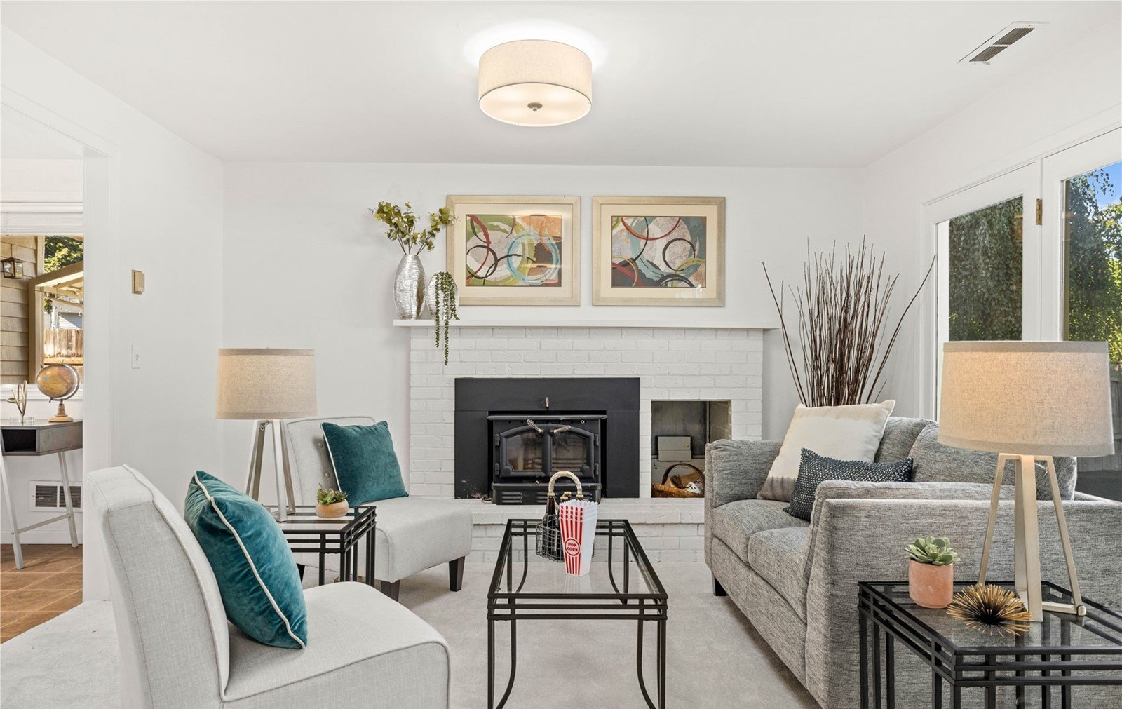 Beautifully staged living room with fireplace and modern decor in South Cove Issaquah home sold by Judah Realty buyer representation