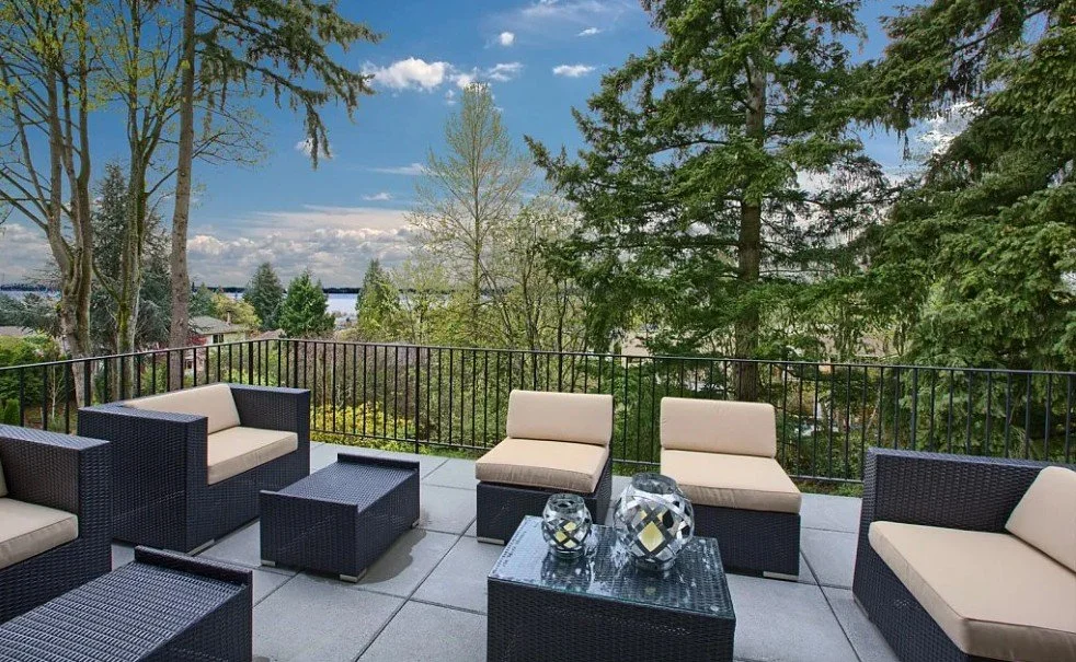 Private view deck off the primary suite in a Casady Homes luxury estate in Kirkland Highlands, overlooking Lake Washington and the Seattle skyline — built by Ben Casady, sold by Freddy Delgadillo