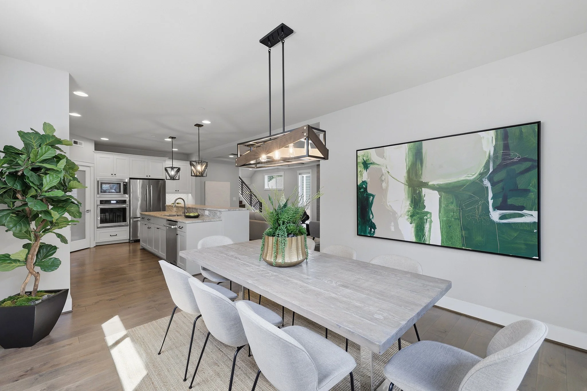 Dining area with modern art and pendant chandelier, English Hill Redmond home for sale