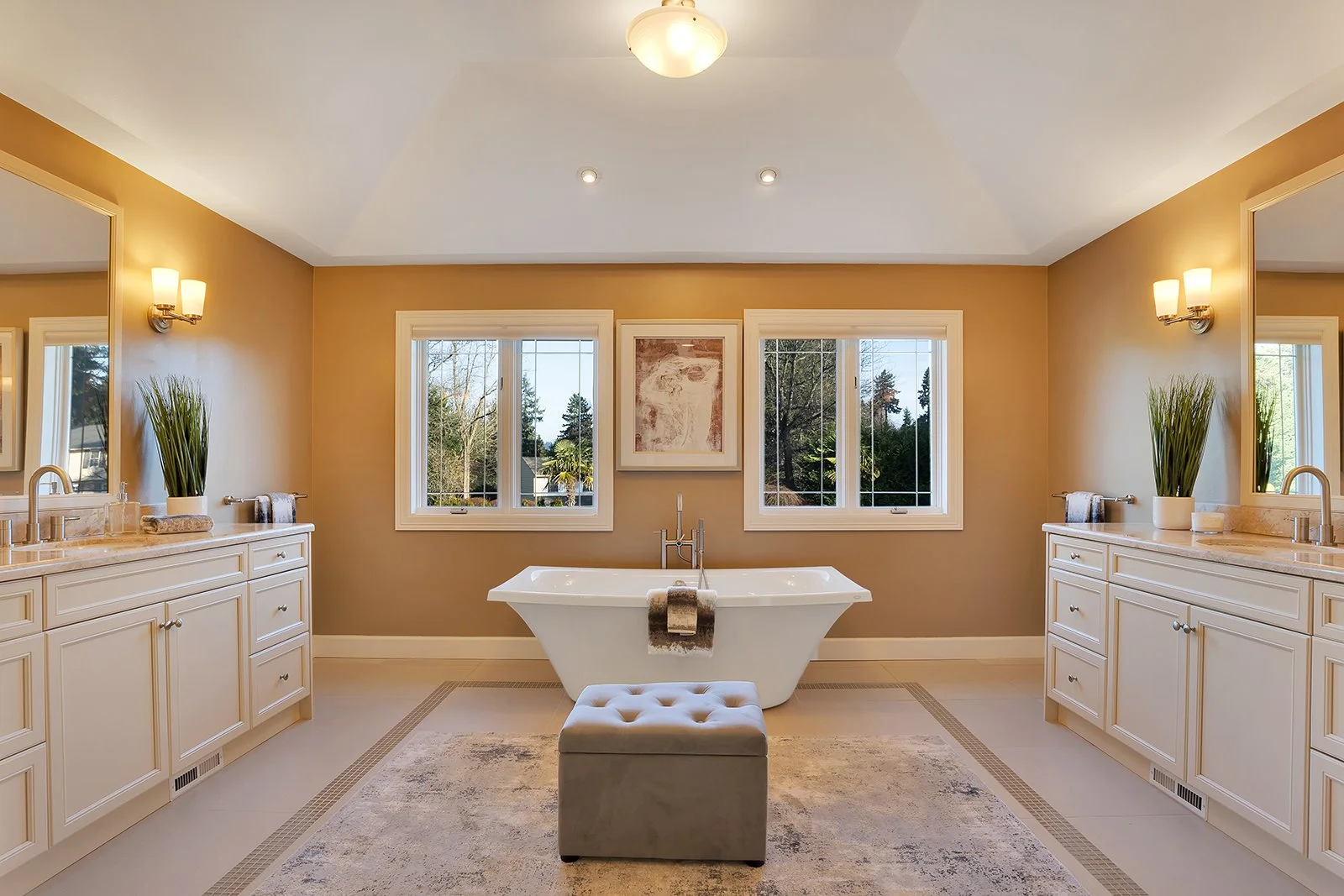 Spa-like primary bathroom with soaking tub, dual vanities, and luxury finishes in Clyde Hill home