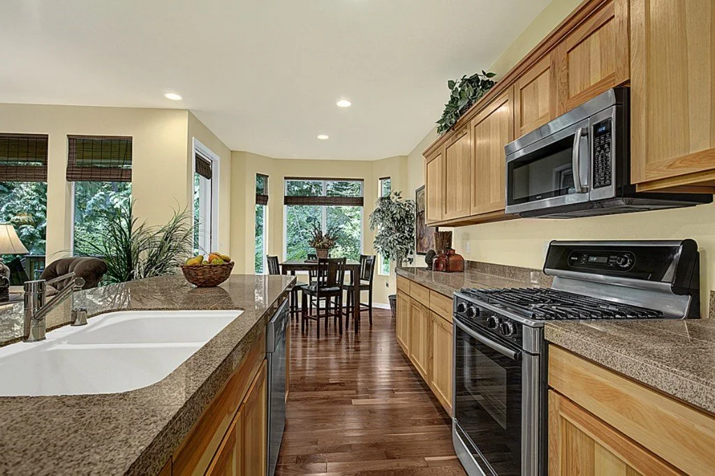 Trilogy Redmond kitchen with granite countertops and stainless steel appliances