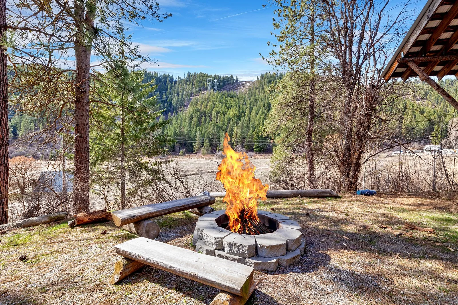 Outdoor fire pit and gathering area at Pine Vista Leavenworth WA with Cascades mountain backdrop on 8 private acres near Chumstick Valley