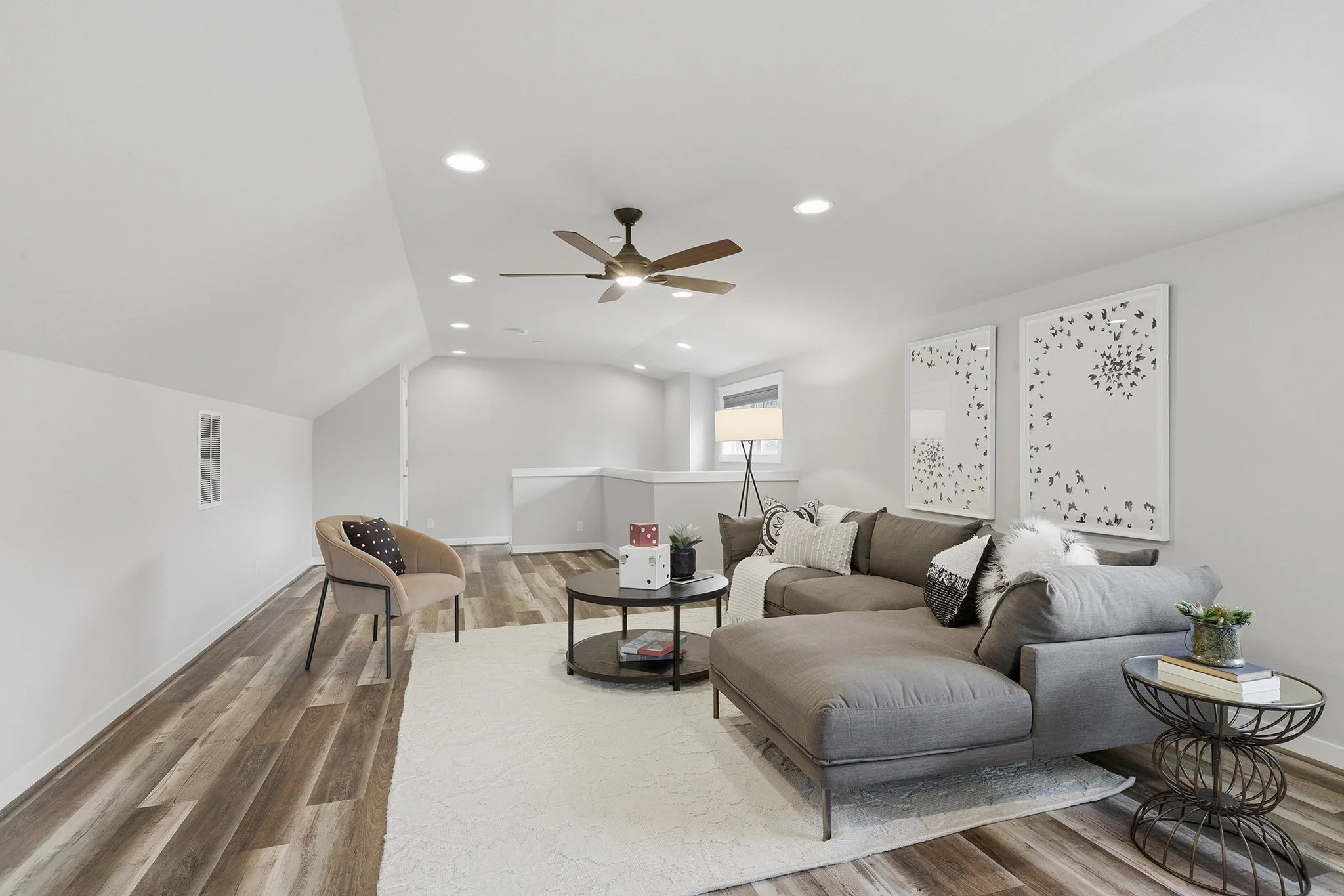 Living room with gray sectional, coffee table, and ceiling fan, Redmond English Hill new construction