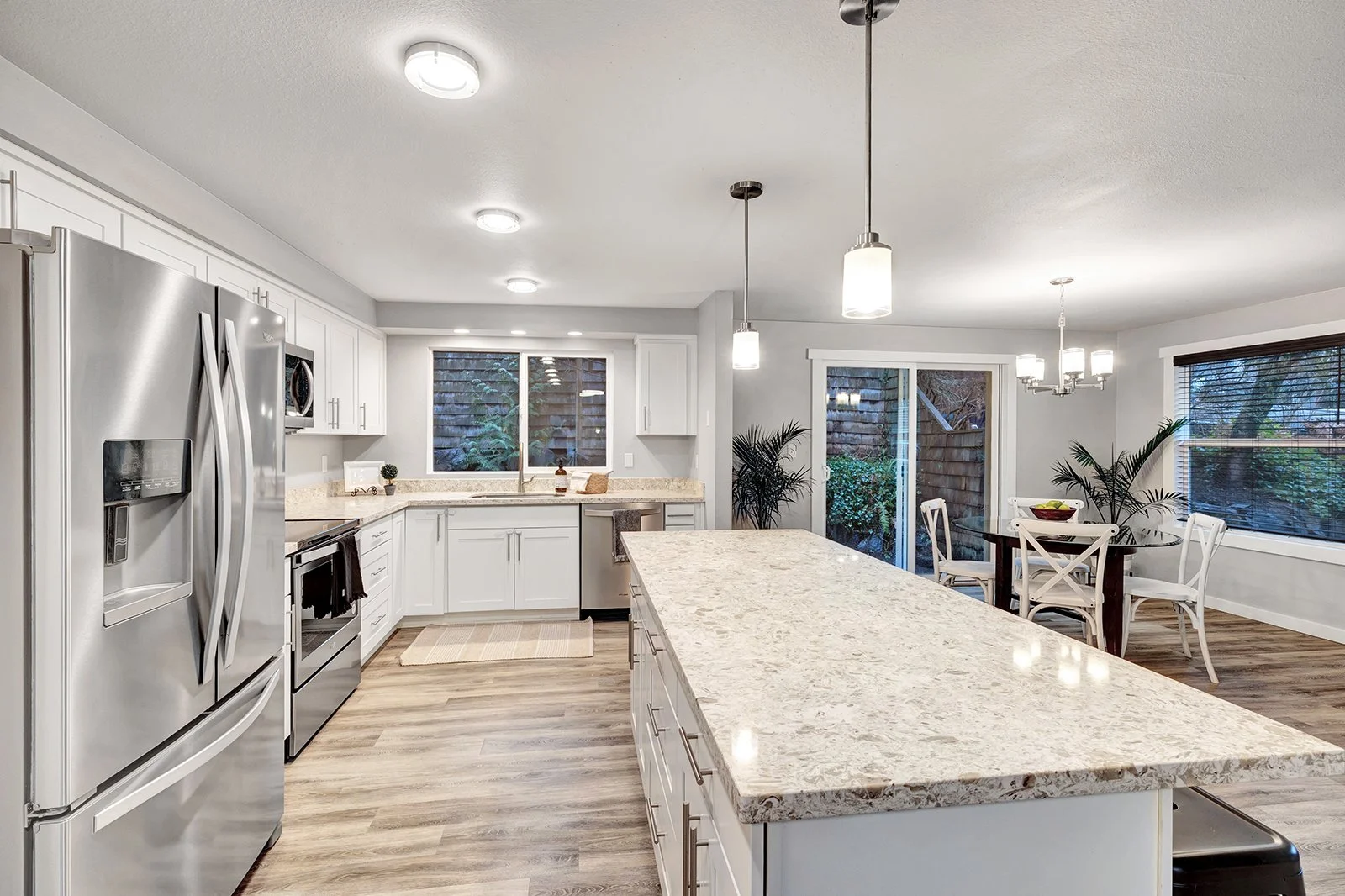 Modern updated kitchen with white cabinetry and stainless appliances in Kenmore home perfect for family cooking and meal preparation
