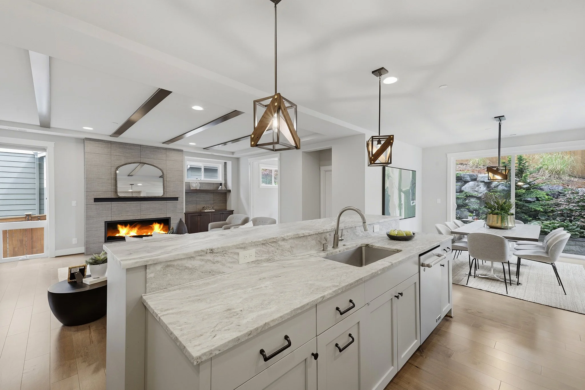 Kitchen island with waterfall quartz countertop and pendant lights, Hawthorne Park Redmond