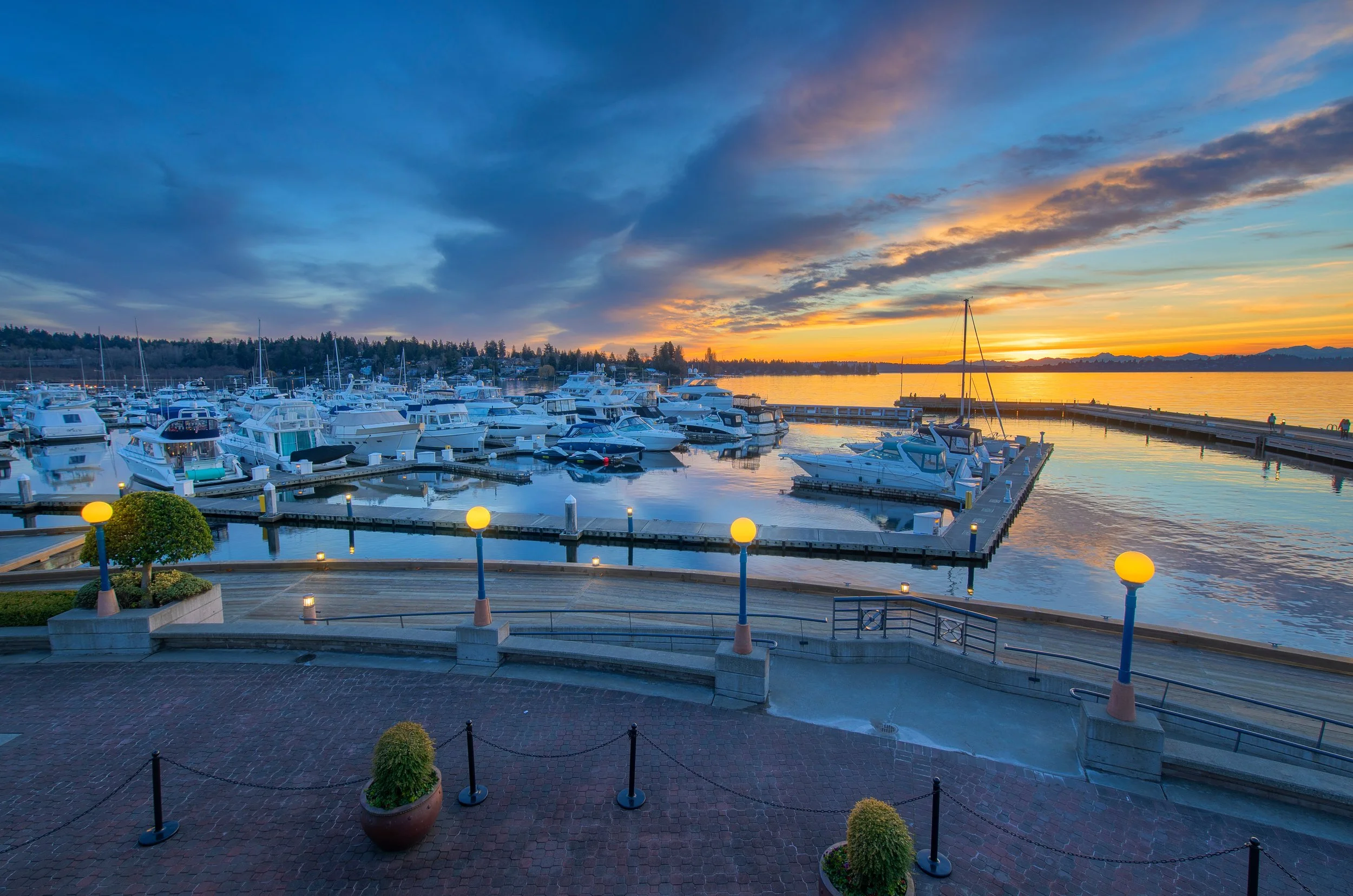 Kirkland waterfront homes and marina on Lake Washington with downtown village, private docks, and sunset views