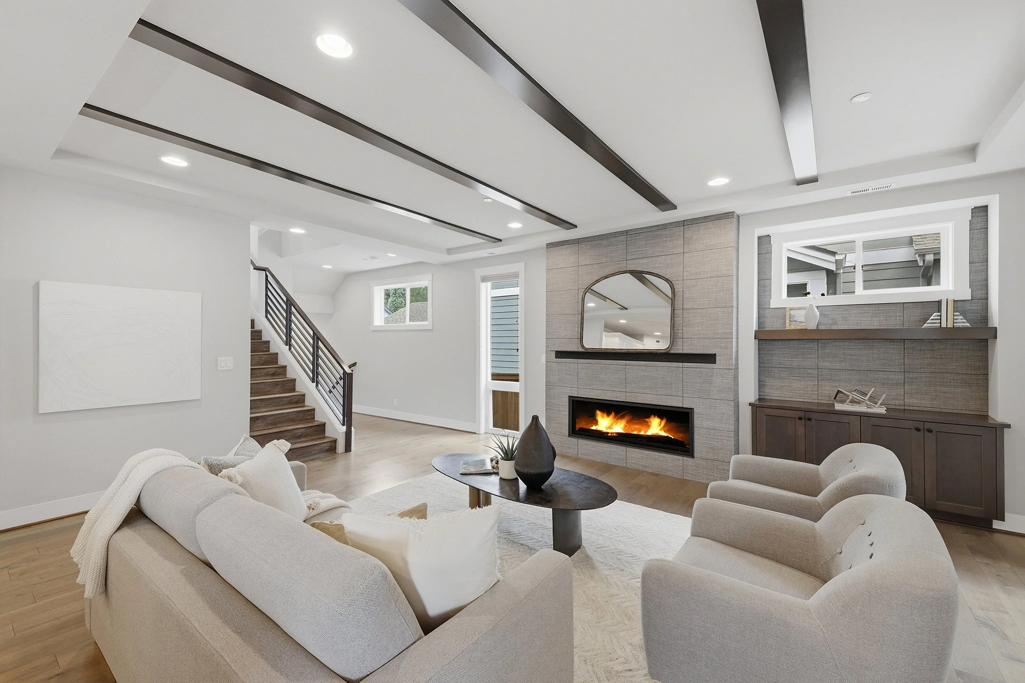 Great room with vaulted beamed ceiling and gas fireplace, English Hill Redmond new construction