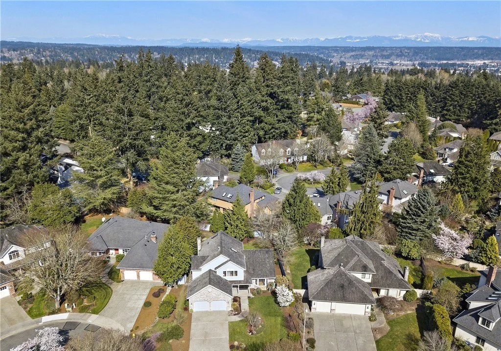 Sidewalk-lined residential street with mature maple and cedar trees in Grass Lawn Redmond