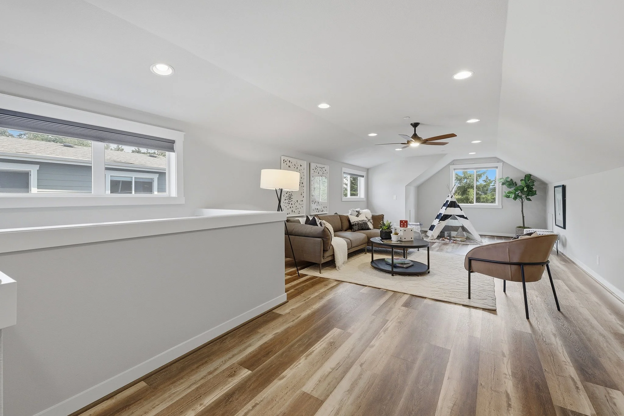 Third-floor bonus room loft with vaulted ceiling, hardwood floors, and railing, English Hill Redmond