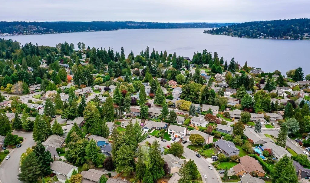 Well-maintained homes on tree-lined streets in South Cove Issaquah with Northwest architecture and manicured yards