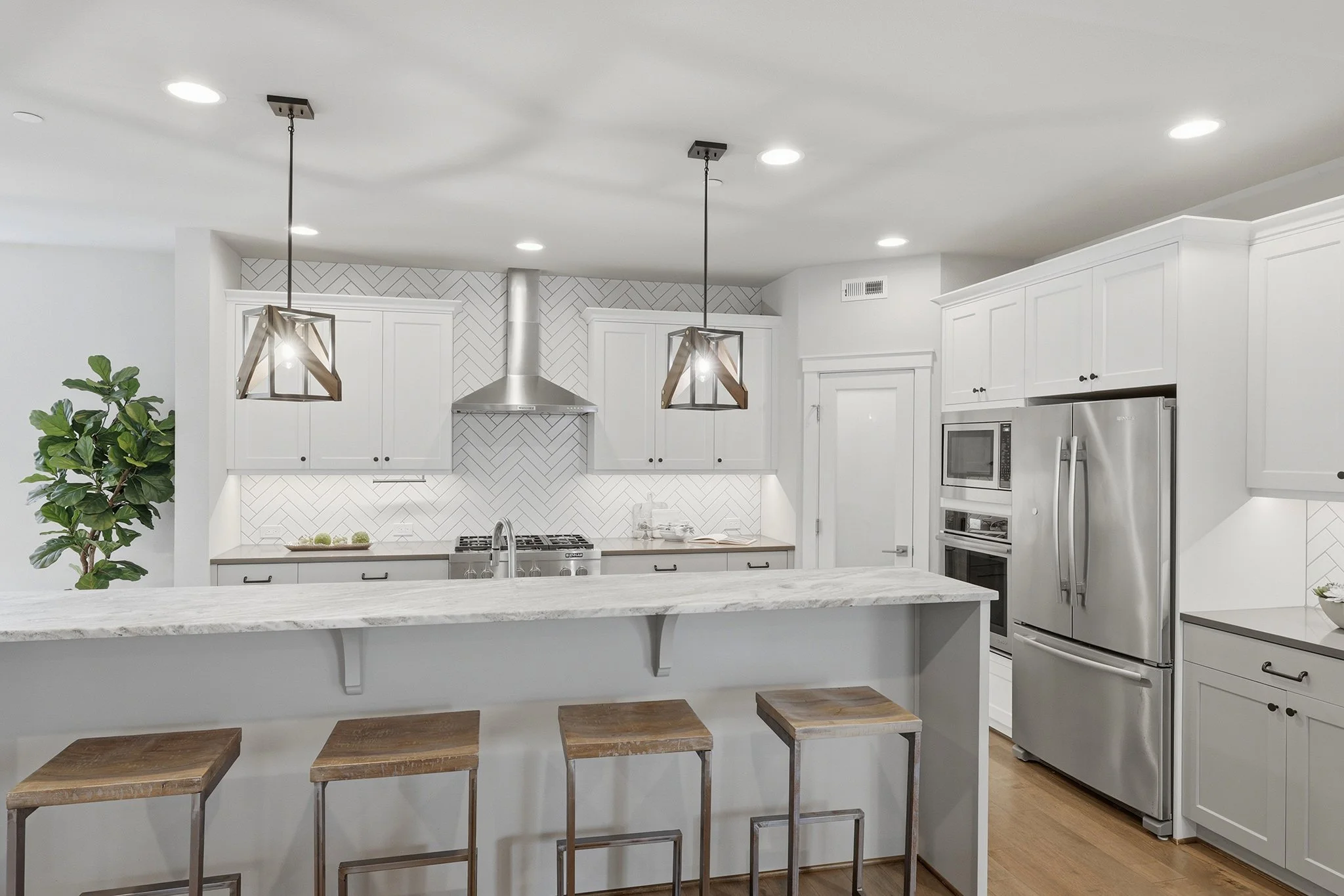 Chef's kitchen with white cabinetry, waterfall island, and pendant lighting, Redmond English Hill