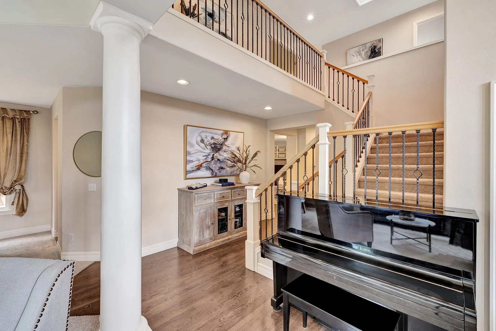 Open-concept living area with grand piano and soaring ceilings — 3208 175th St SE Bothell WA 98012
