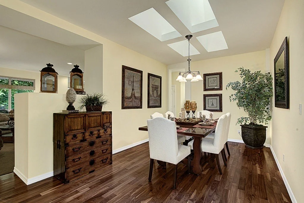 Trilogy home dining room with custom walnut hardwood floors and natural skylights