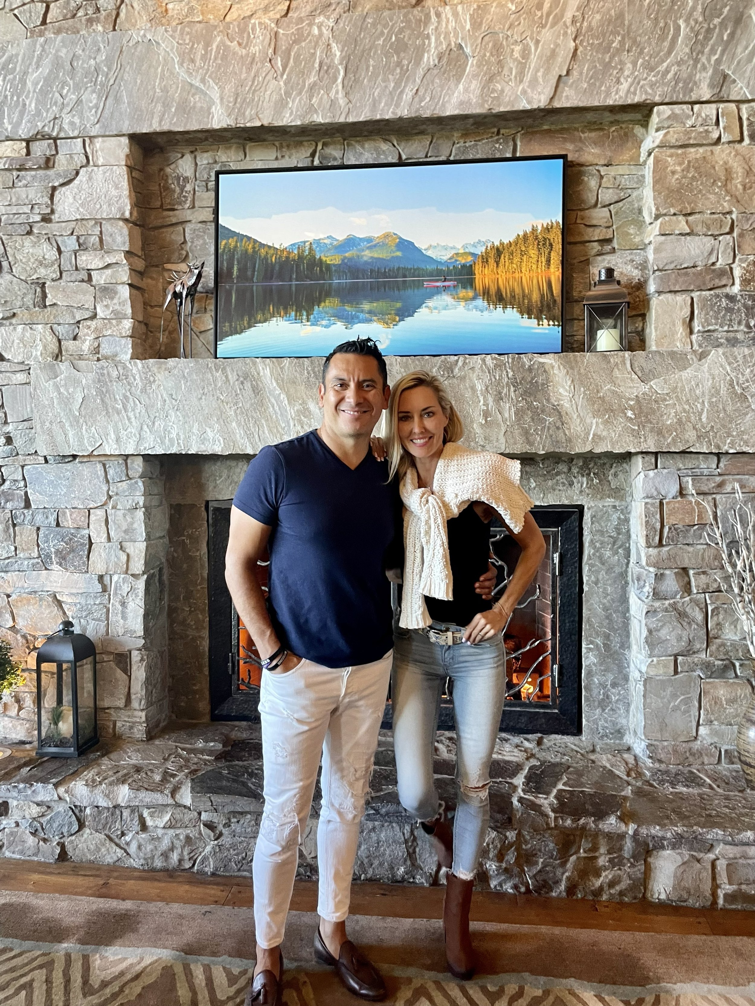 Freddy & Kimberly Delgadillo at Suncadia Lodge stone fireplace lounge, Cle Elum WA — resort real estate specialist with personal Suncadia experience
