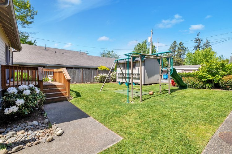6,000 square foot lot with partially fenced yard, playset, workshop, and deck in Downtown Issaquah walkable neighborhood