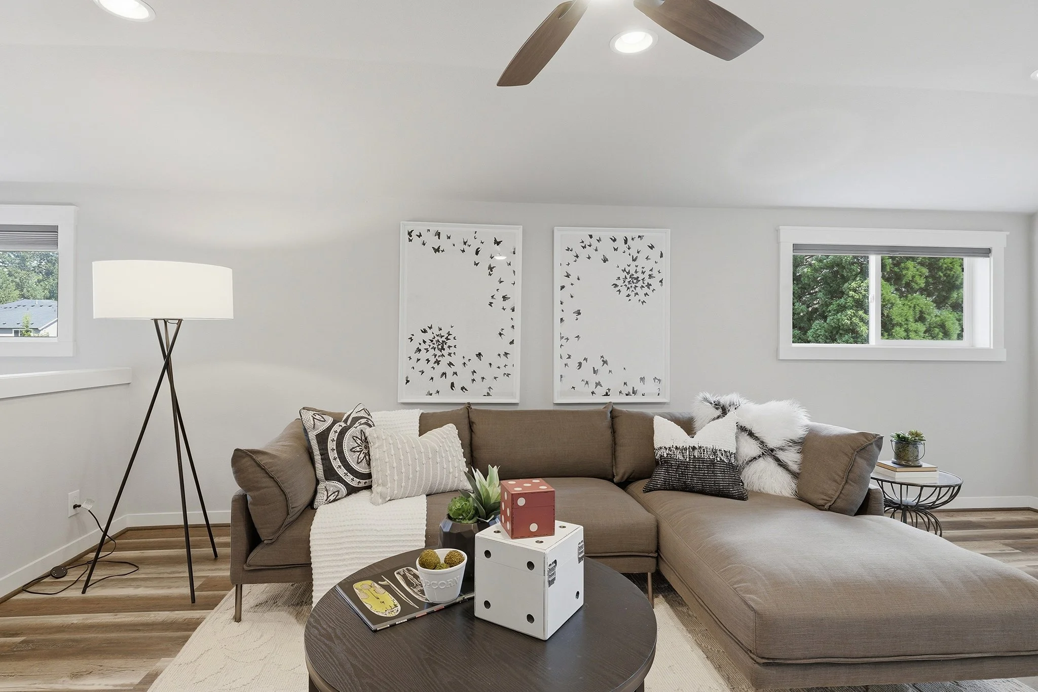 Living room with brown sectional sofa and modern floor lamp, English Hill Redmond home for sale