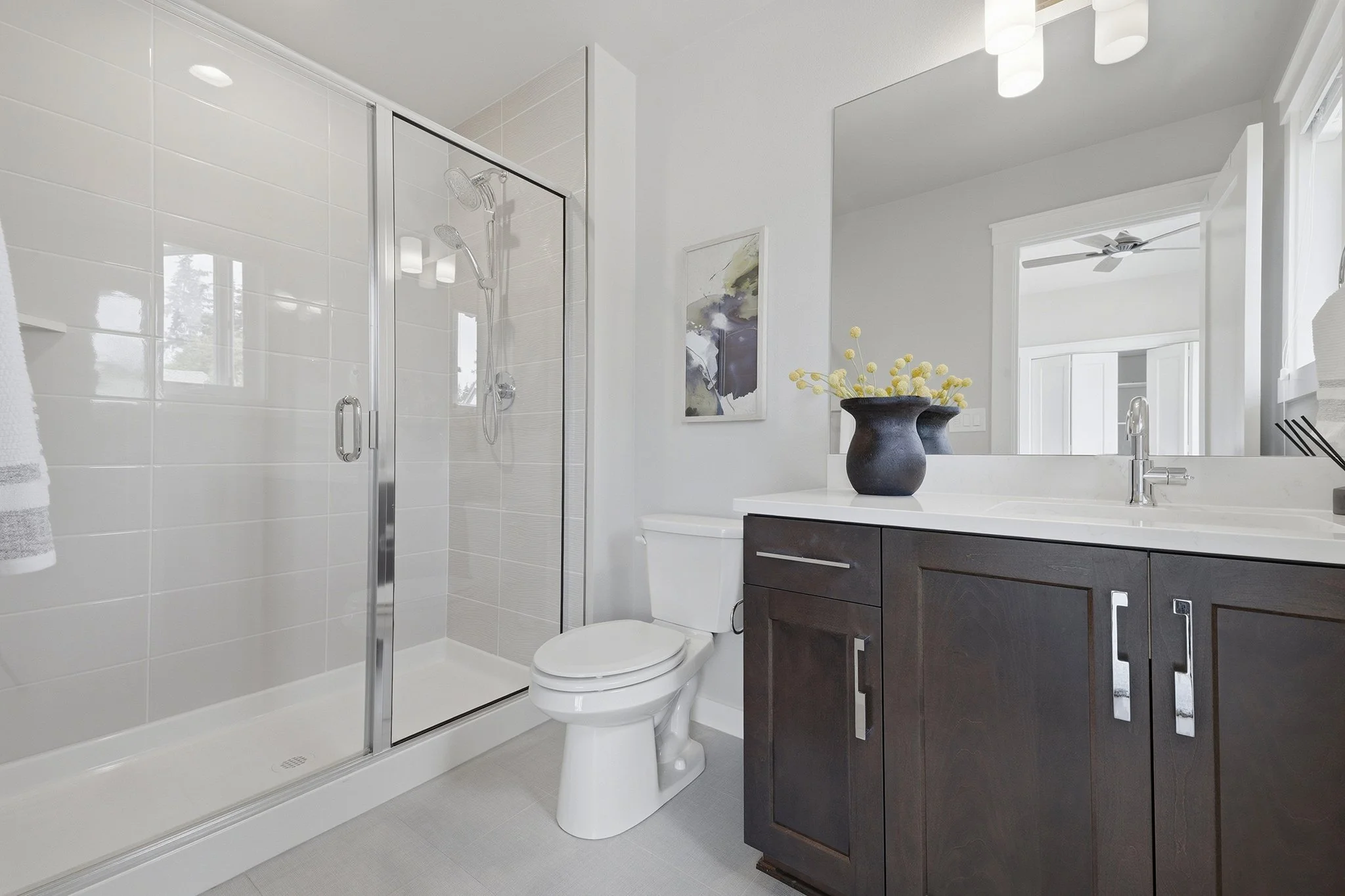 Full bathroom with shower-tub combo, dark vanity, and framed mirror, Redmond English Hill home