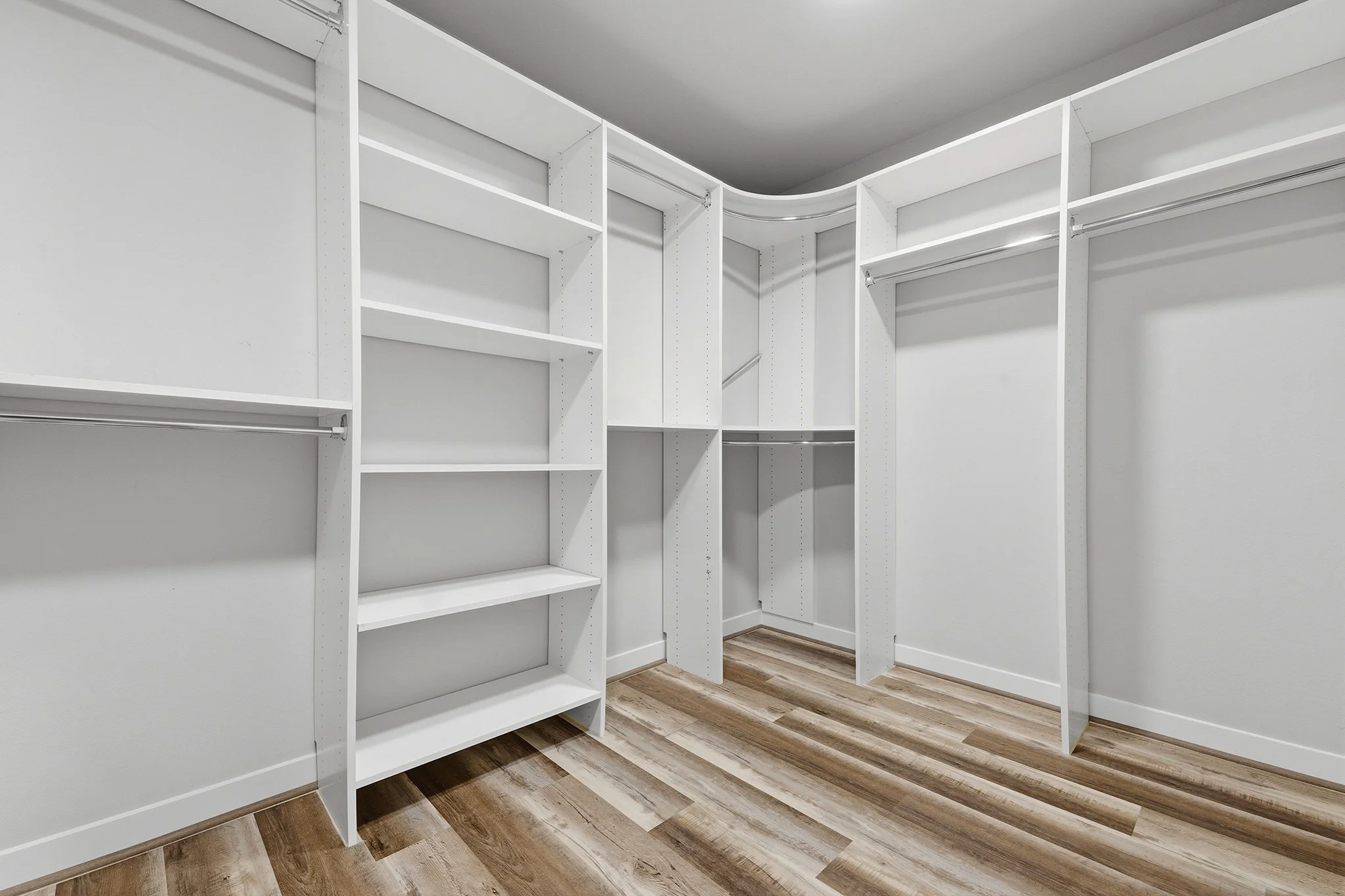 Primary walk-in closet with built-in wood shelving, Redmond English Hill new construction home