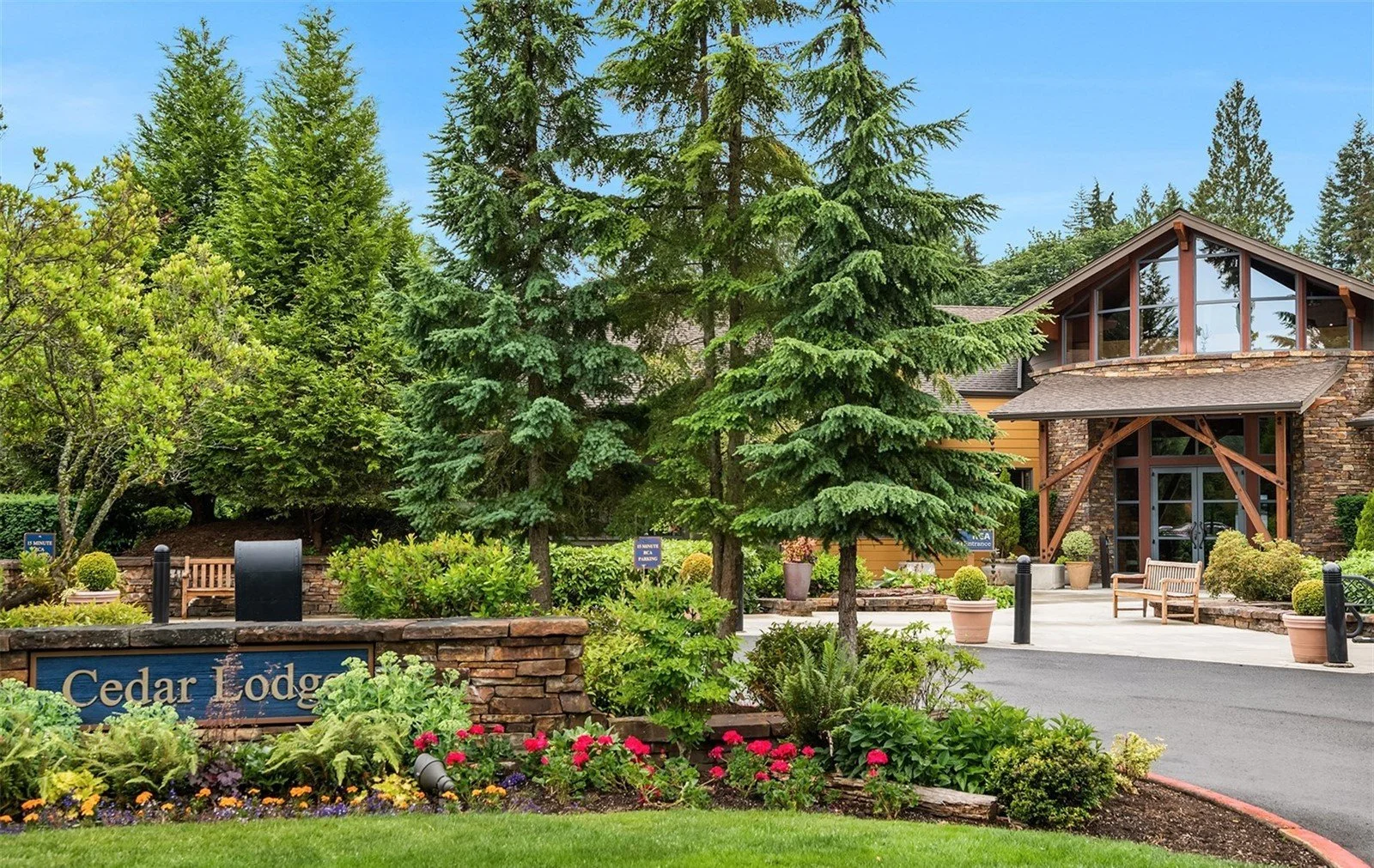 Cedar Lodge clubhouse exterior surrounded by mature             landscaping at Trilogy Redmond Ridge