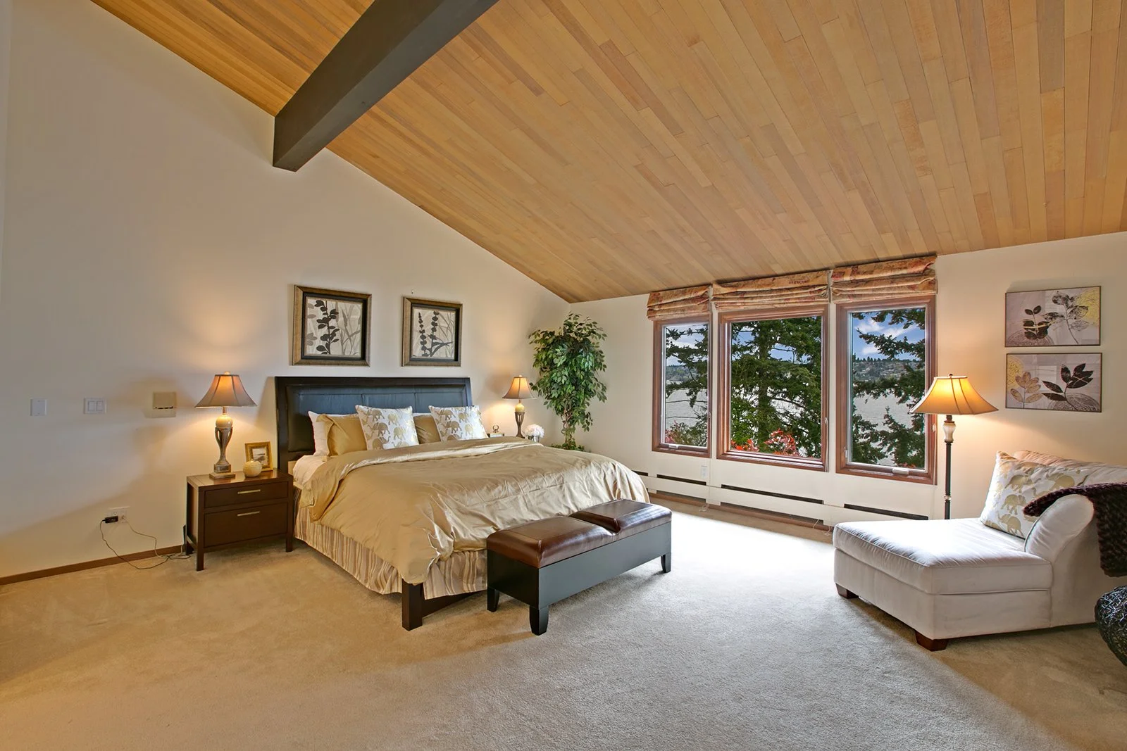 Primary bedroom 8383 Seashore Drive Mercer Island  vaulted ceilings, views of Lake Washington and manicured lawns