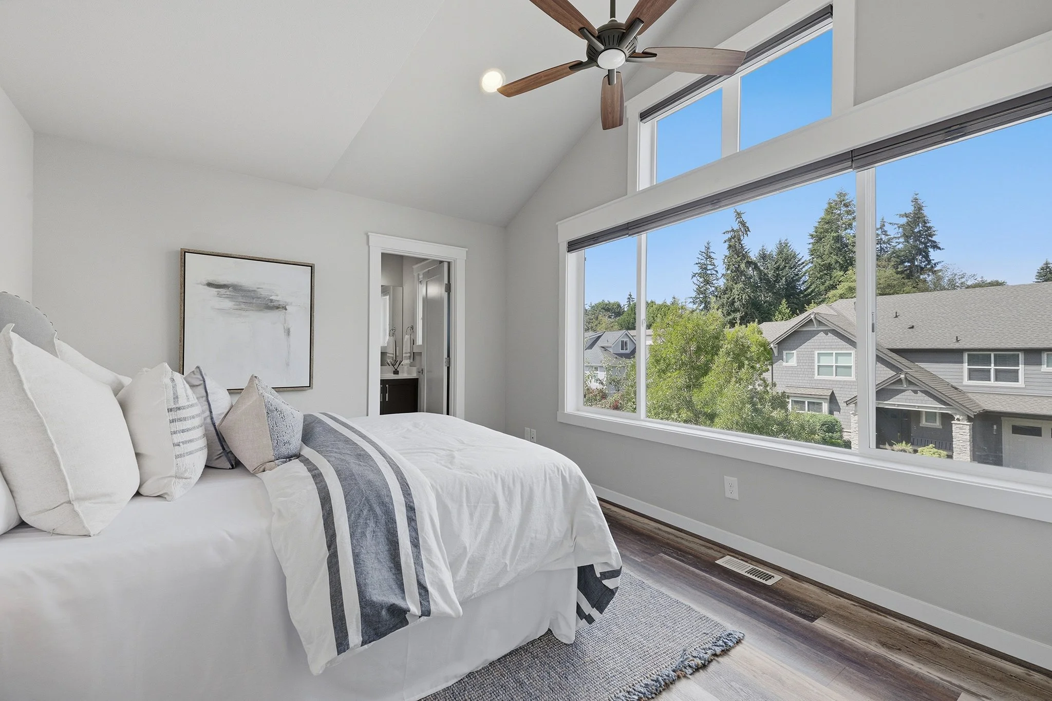 Bedroom with vaulted ceiling and large picture window, English Hill Redmond luxury home