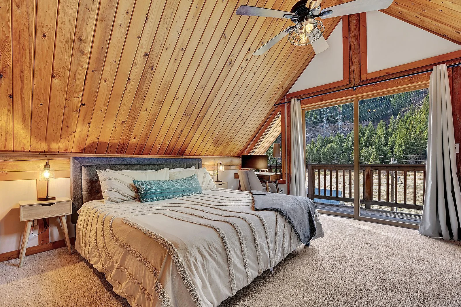 Upstairs king loft bedroom suite at Pine Vista Leavenworth WA with dramatic A-frame ceiling skylights and private full bathroom in mountain cabin retreat