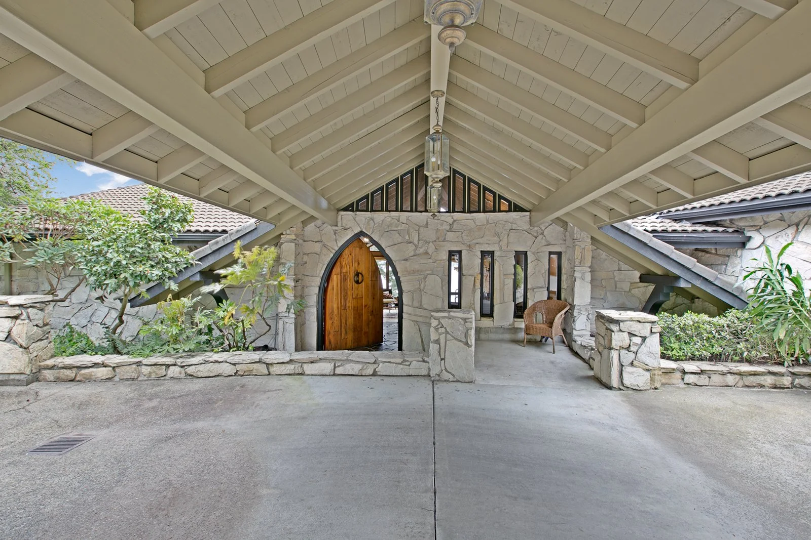 Entrance door to 8383 Seashore Drive Mercer Island with covered porte-cochere and large private entrance custom door