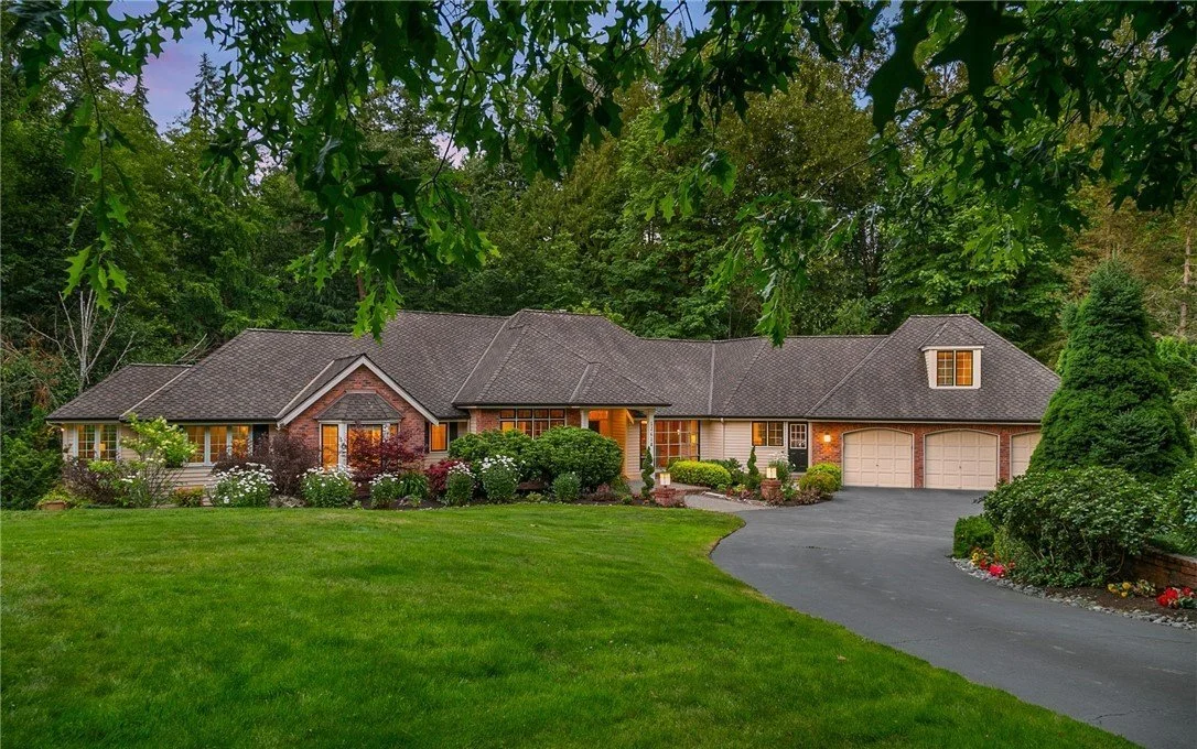 Single-story brick estate home with mature landscaping in the Bear Creek neighborhood, Eastside Washingto