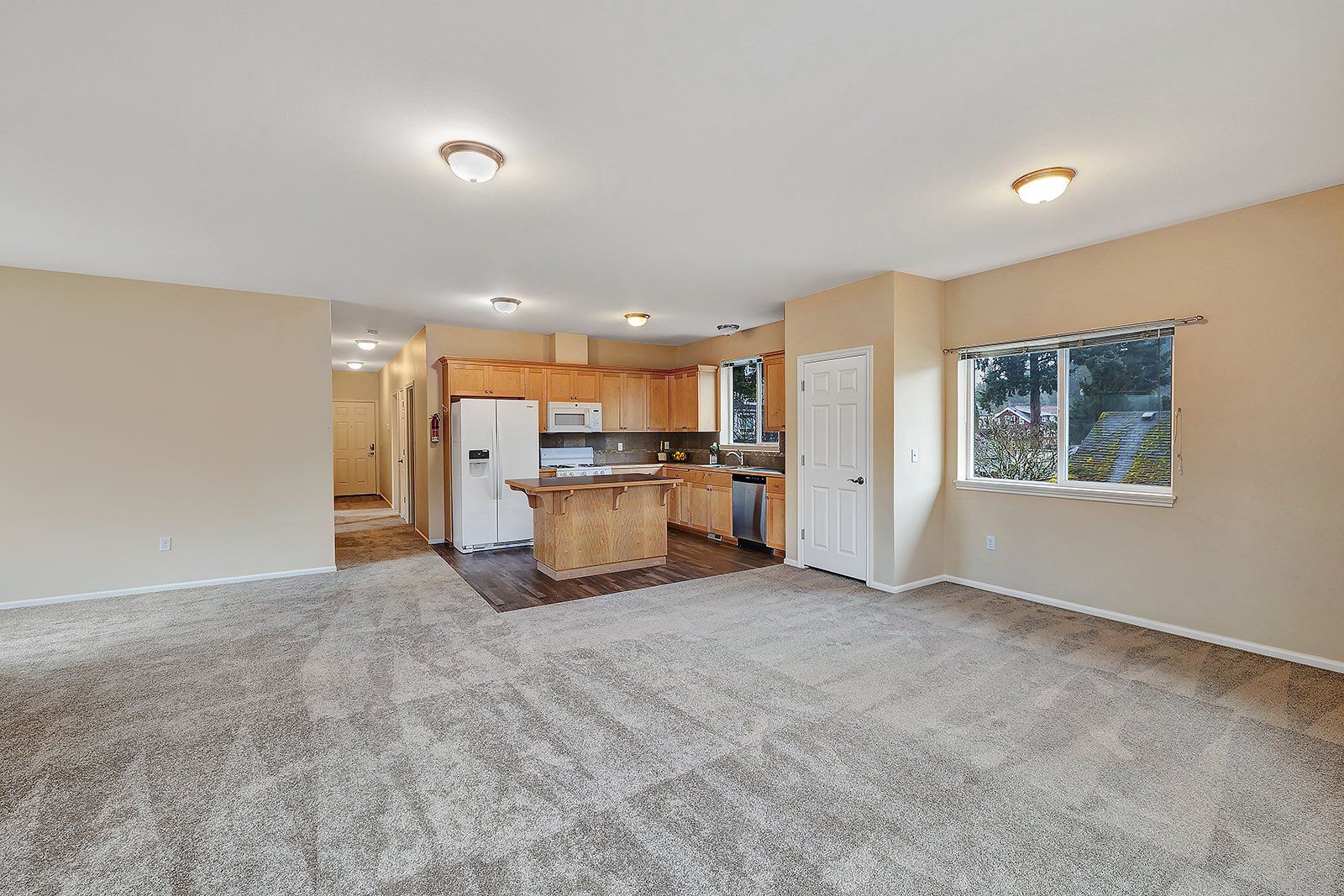 Spacious open living and dining area with dual windows and generous natural light in upper unit of Old Town Issaquah duplex at 260 SE Andrews Street — 1,380 sq ft unit with Tiger Mountain territorial views
