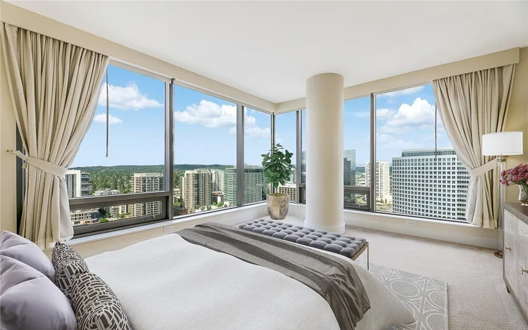 Primary bedroom with floor-to-ceiling city views at One Lincoln Tower