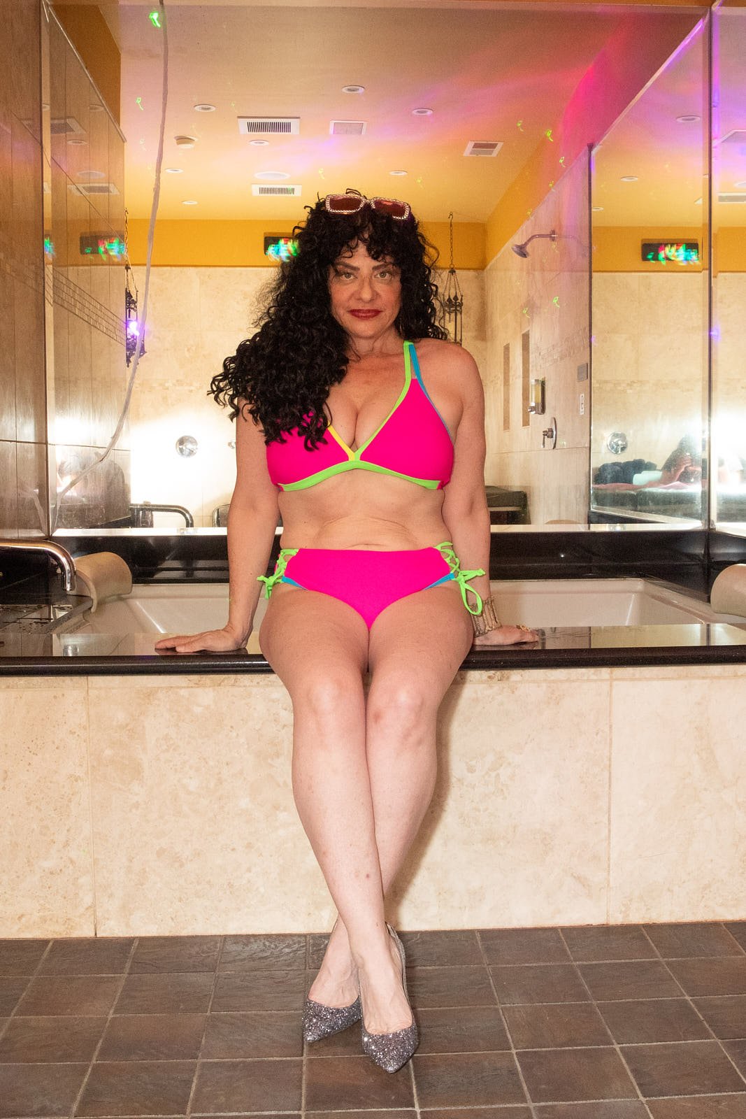 70's style boudoir photo in a hot tub with vibrant lights, capturing a fun "skin mag" fantasy in Downtown Oakland. Photo by Rikki Ward, Juicy Fruit Boudoir - Bay Area.