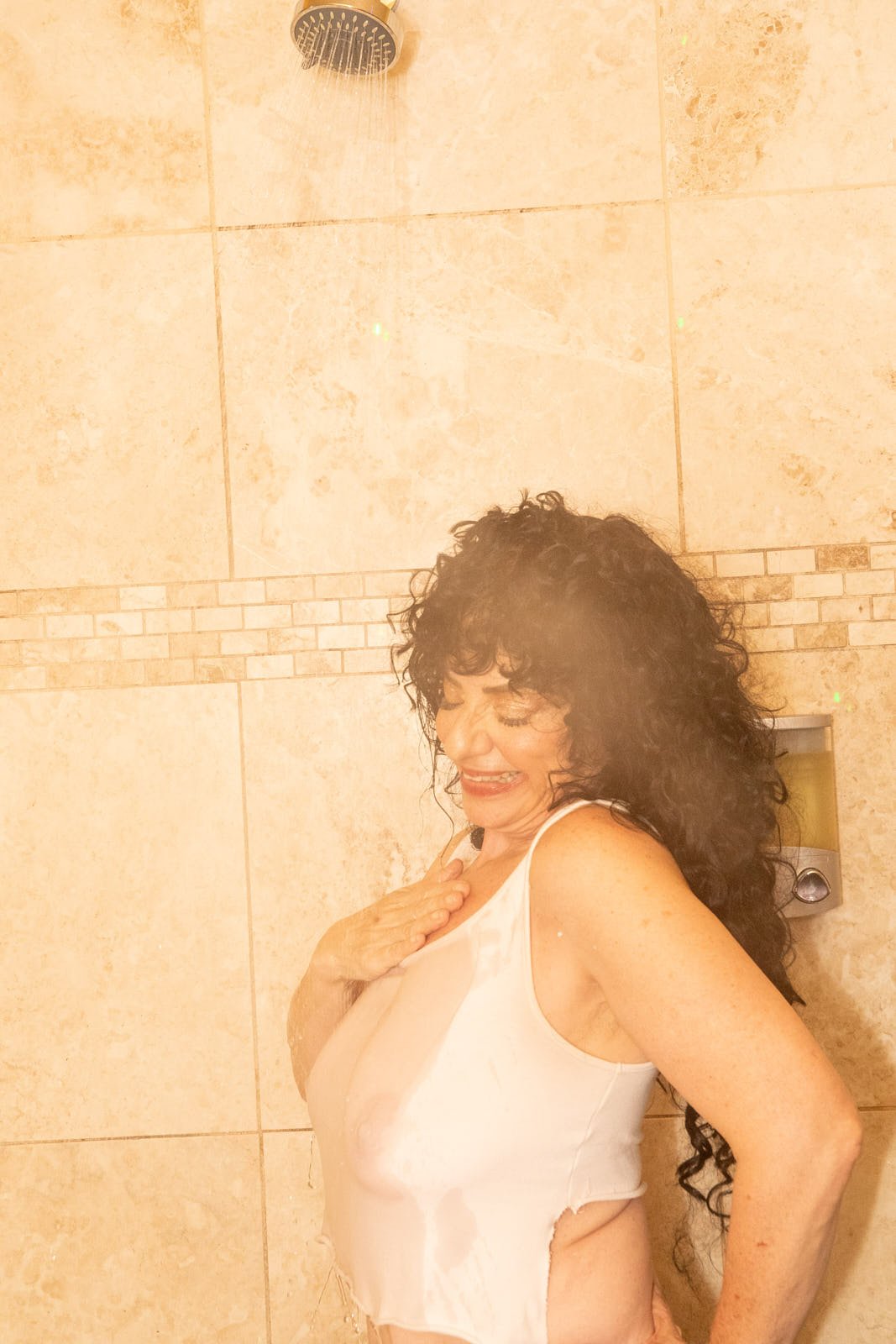 Steamy shower portrait captured during an empowering boudoir session at a bath house in a Downtown Oakland location. Boudoir photography by Rikki Ward.