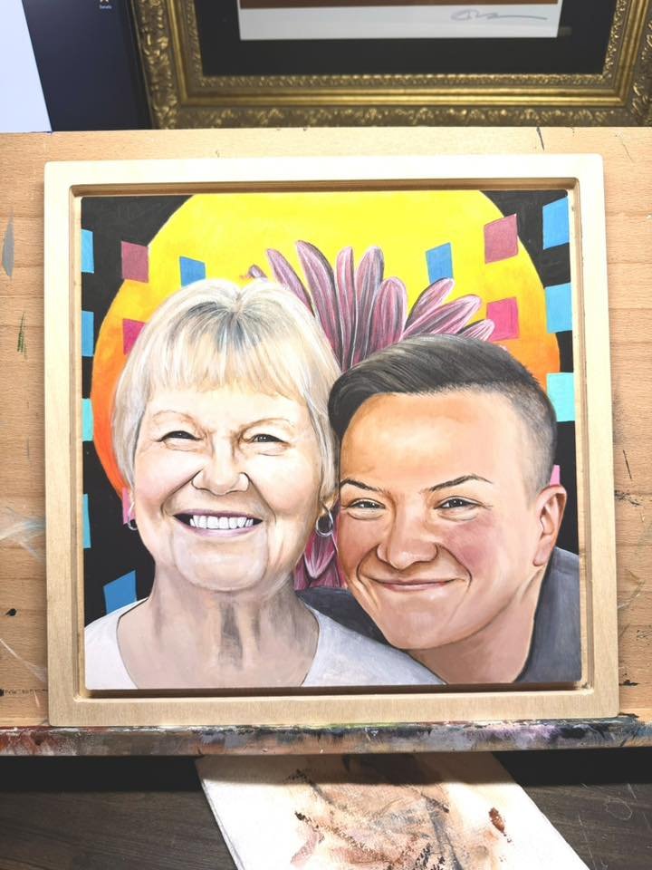 Colorful portrait of an elderly woman and a young man, both smiling, with a vibrant yellow and pink background featuring abstract shapes and a large flower.