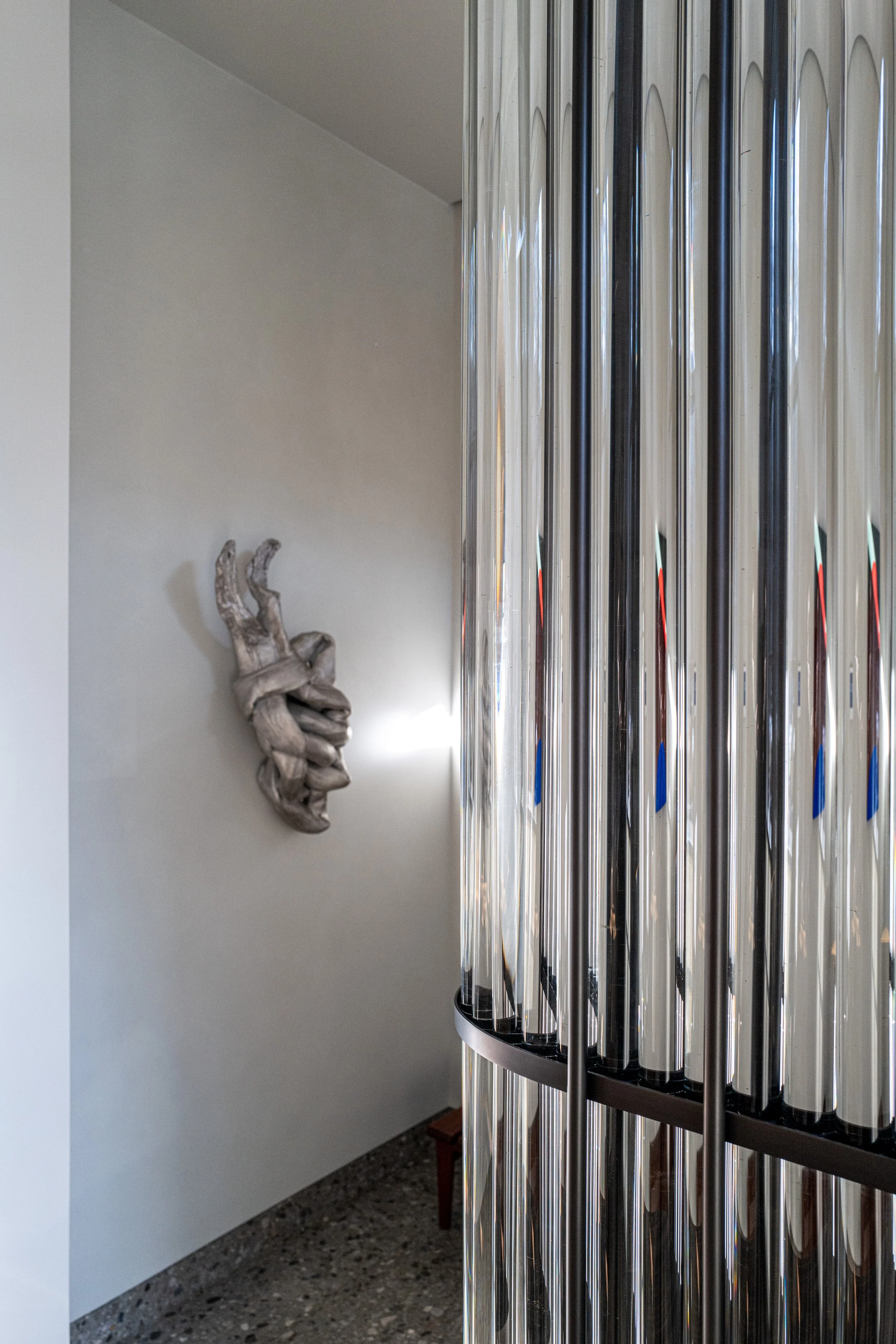 Silver metallic wall sculpture beside a custom fluted-glass partition in a West Village townhouse by JG Neukomm Architecture