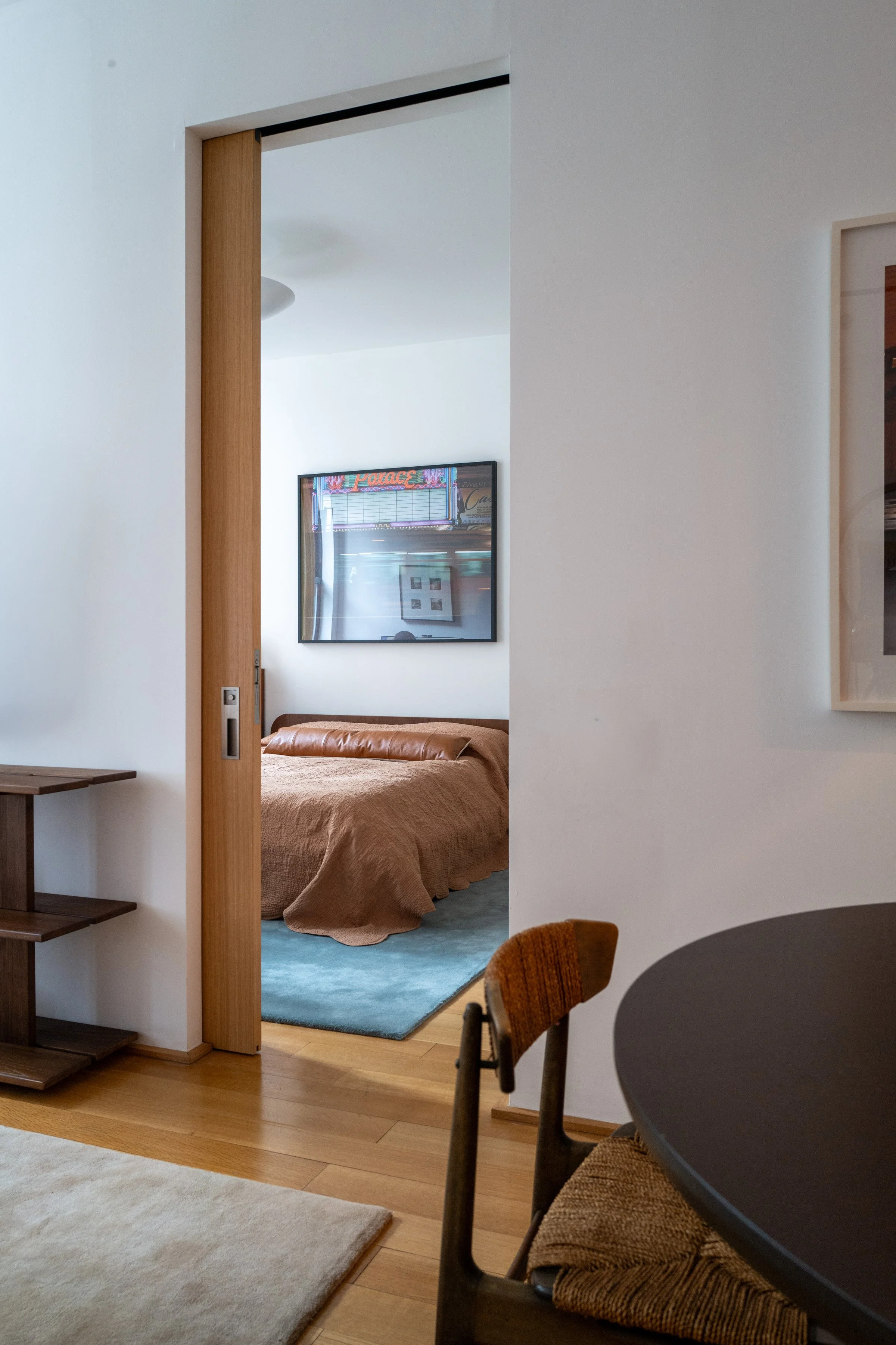Interior threshold with oak sliding partition opening from dining area into the bedroom