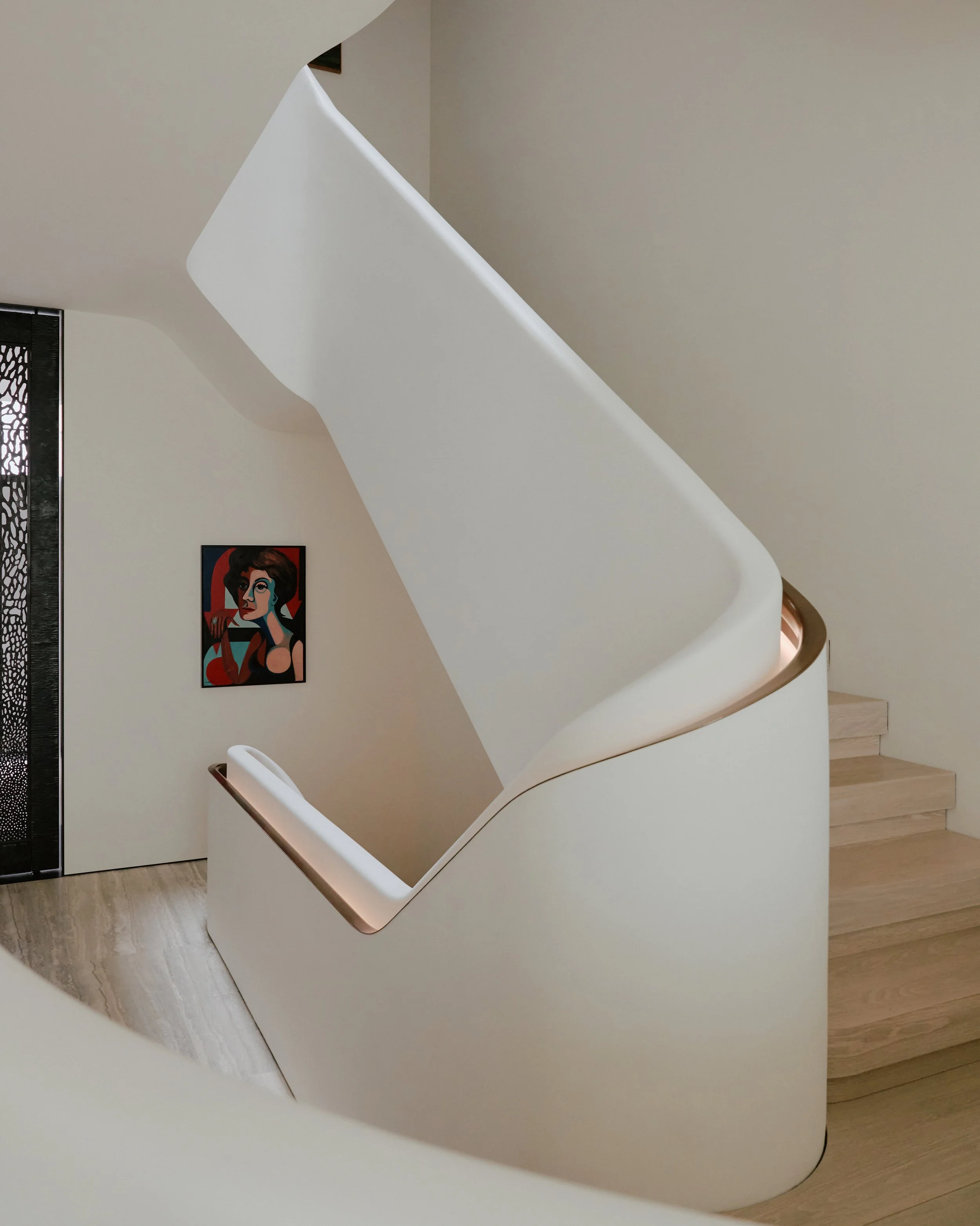 Sculptural white plaster staircase beside a contemporary painting in a West Village townhouse by JG Neukomm Architecture