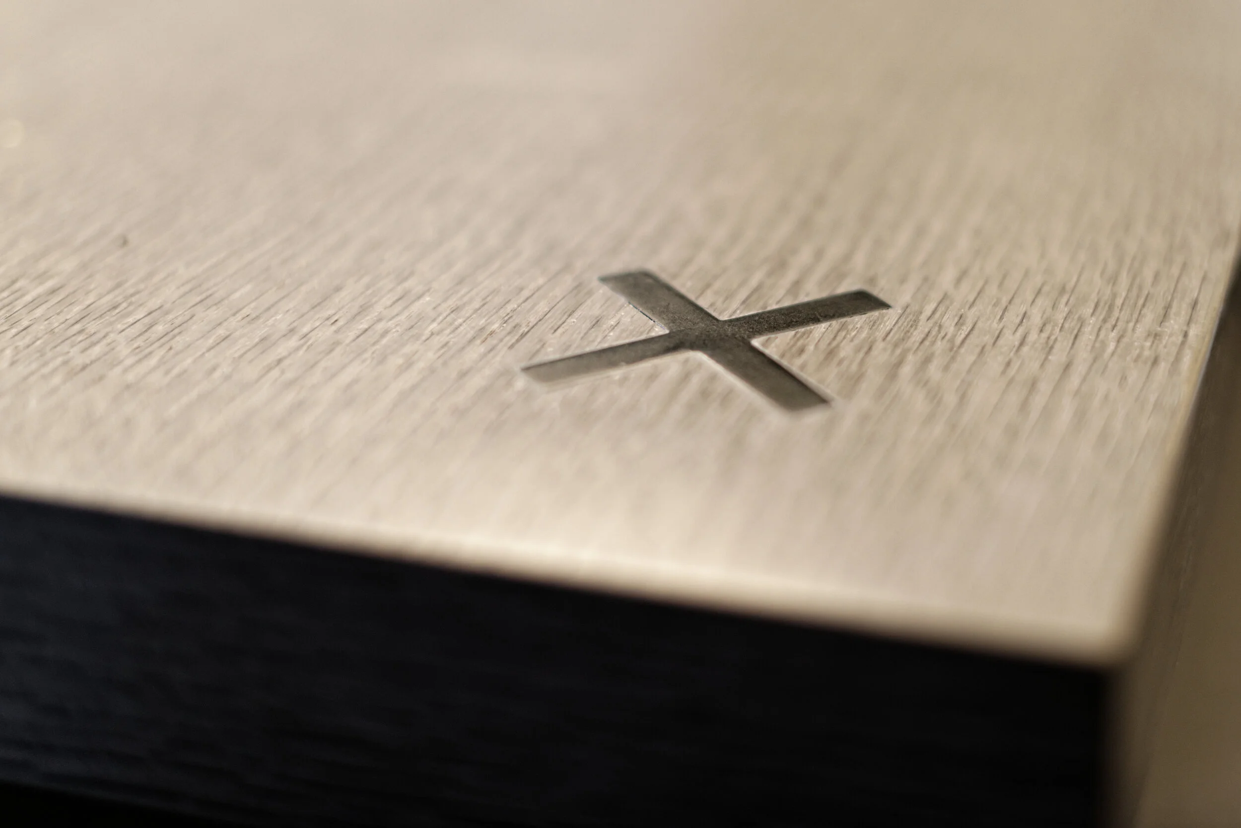 JGNA residence millwork detail of an inlaid metal cross marker on a cerused oak cabinet top