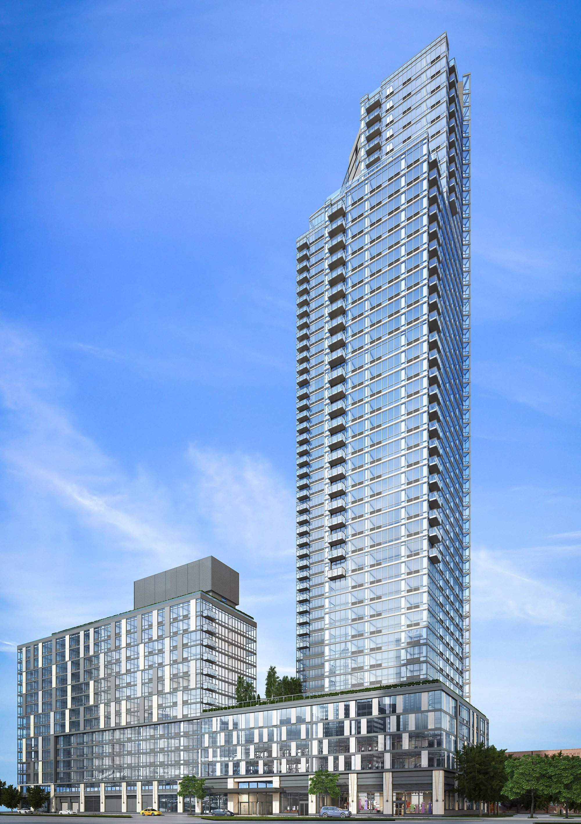 JGNA residential tower exterior with a glass-balcony facade against a clear blue sky