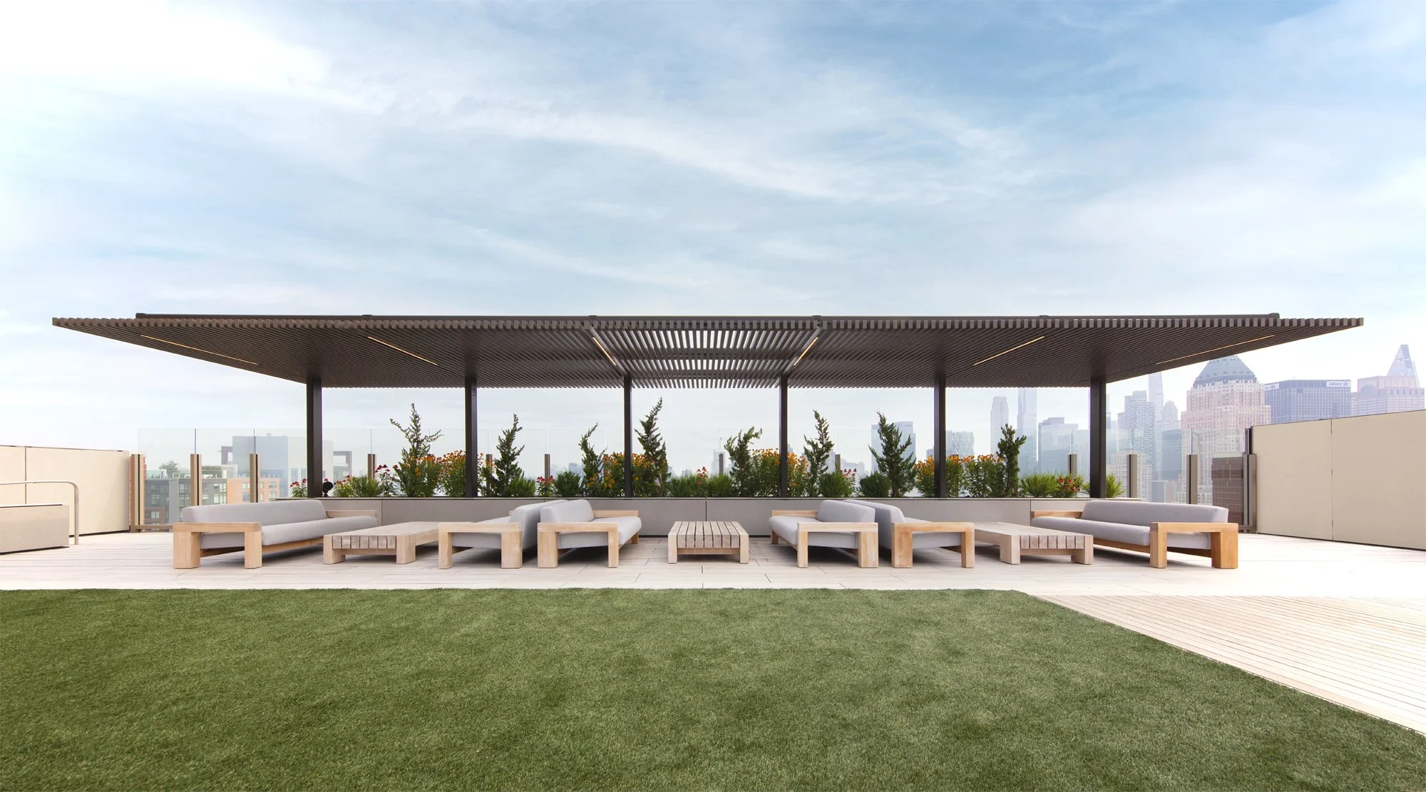 JGNA residential rooftop pavilion with a slatted timber canopy, daybeds, lawn, and a distant city skyline