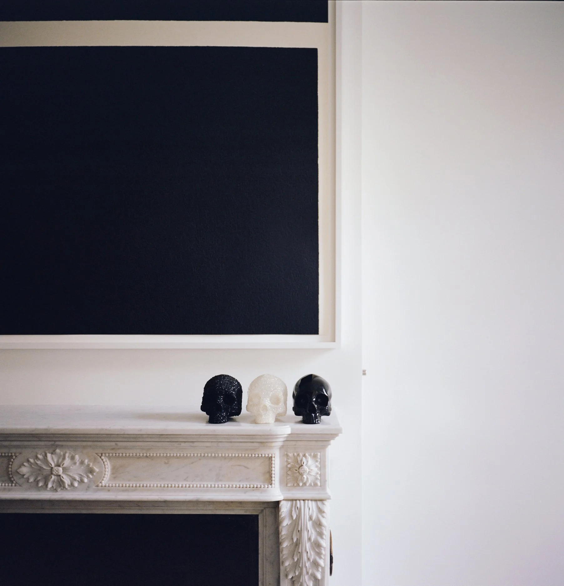 up close of fireplace and modern artwork in living room of townhouse by JGNA