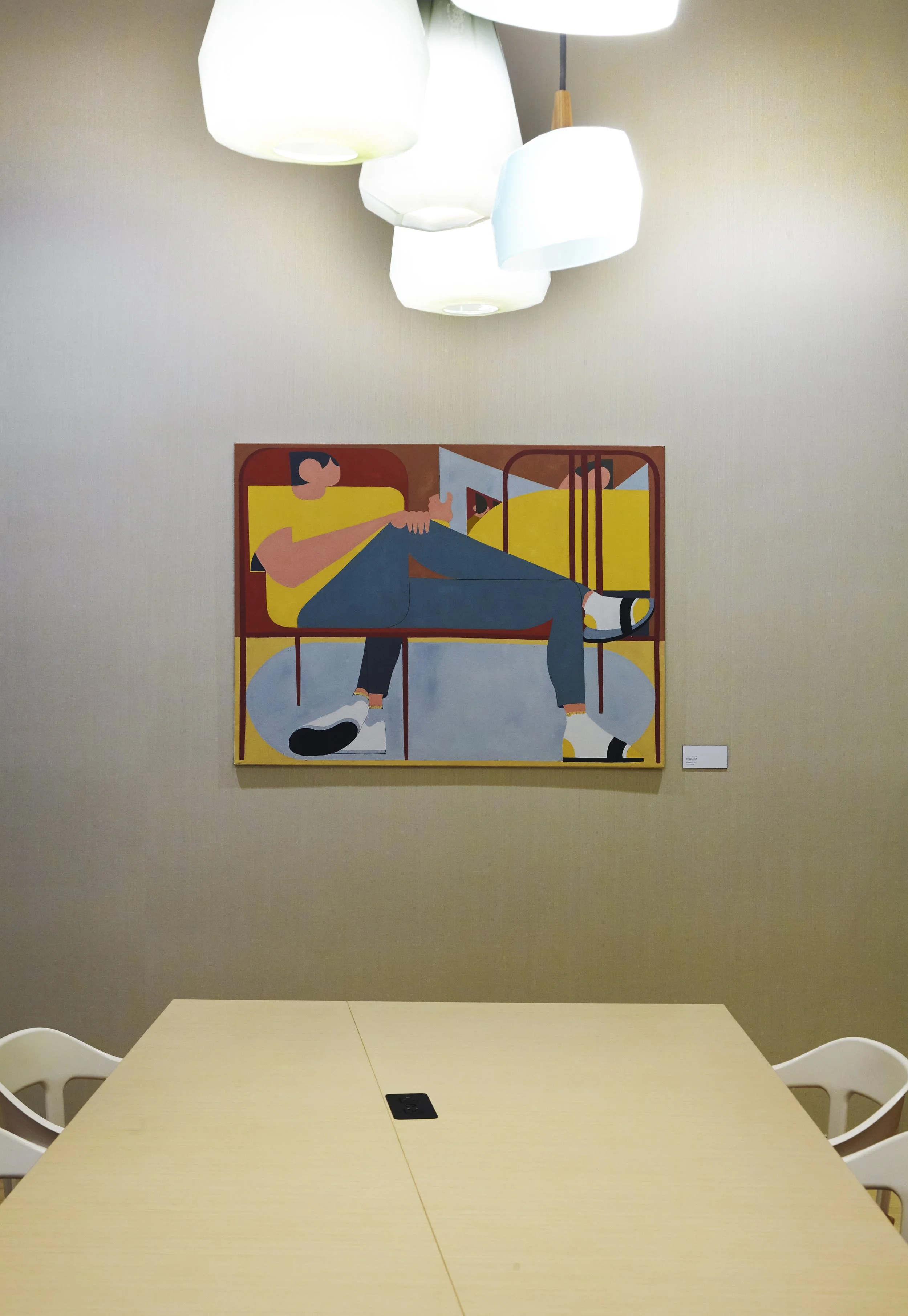 JGNA residential meeting room with a figurative painting, a cluster of white pendants, and a pale table