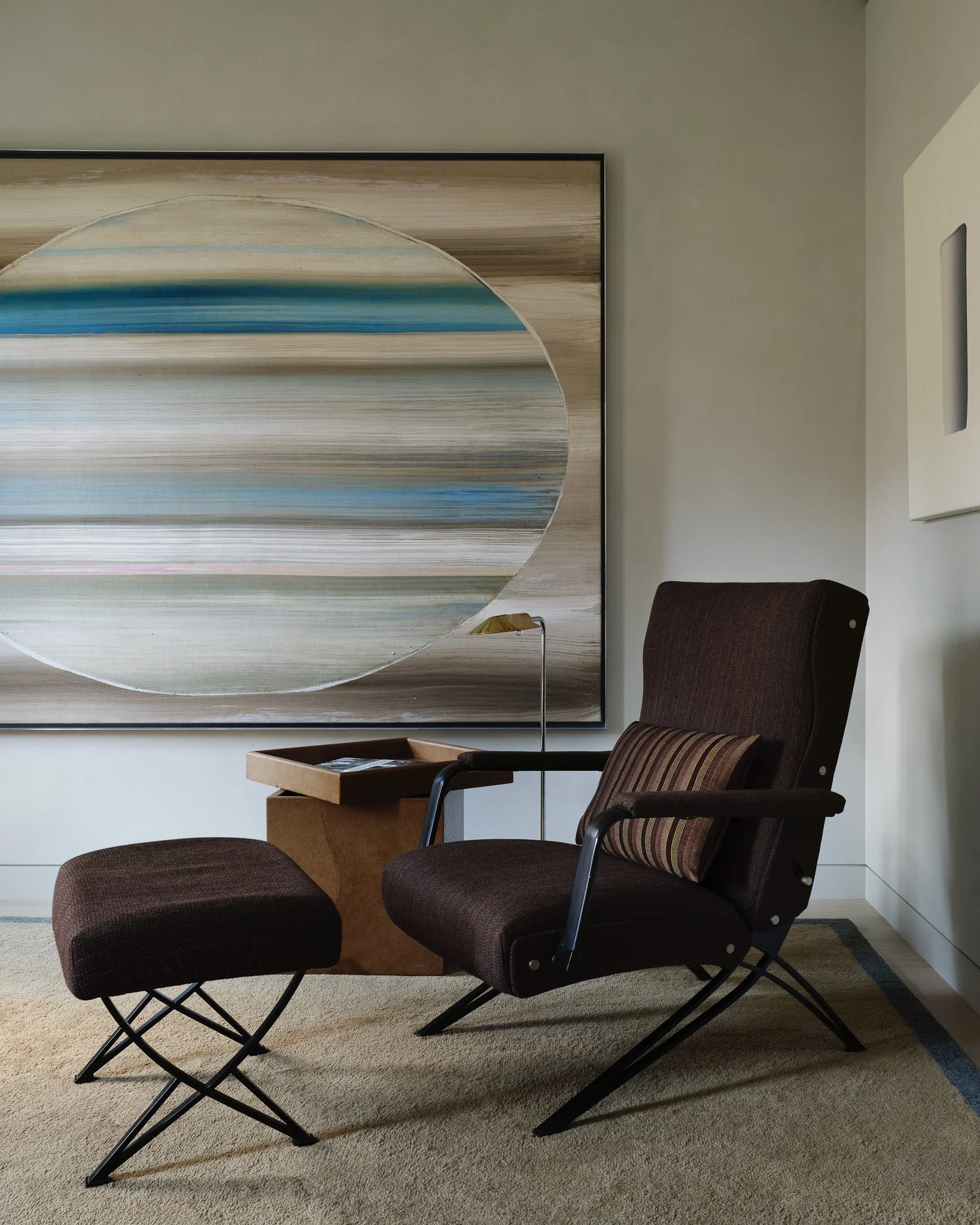 brown lounge chair with wooden side table and modern painting in a West Village townhouse by JG Neukomm Architecture