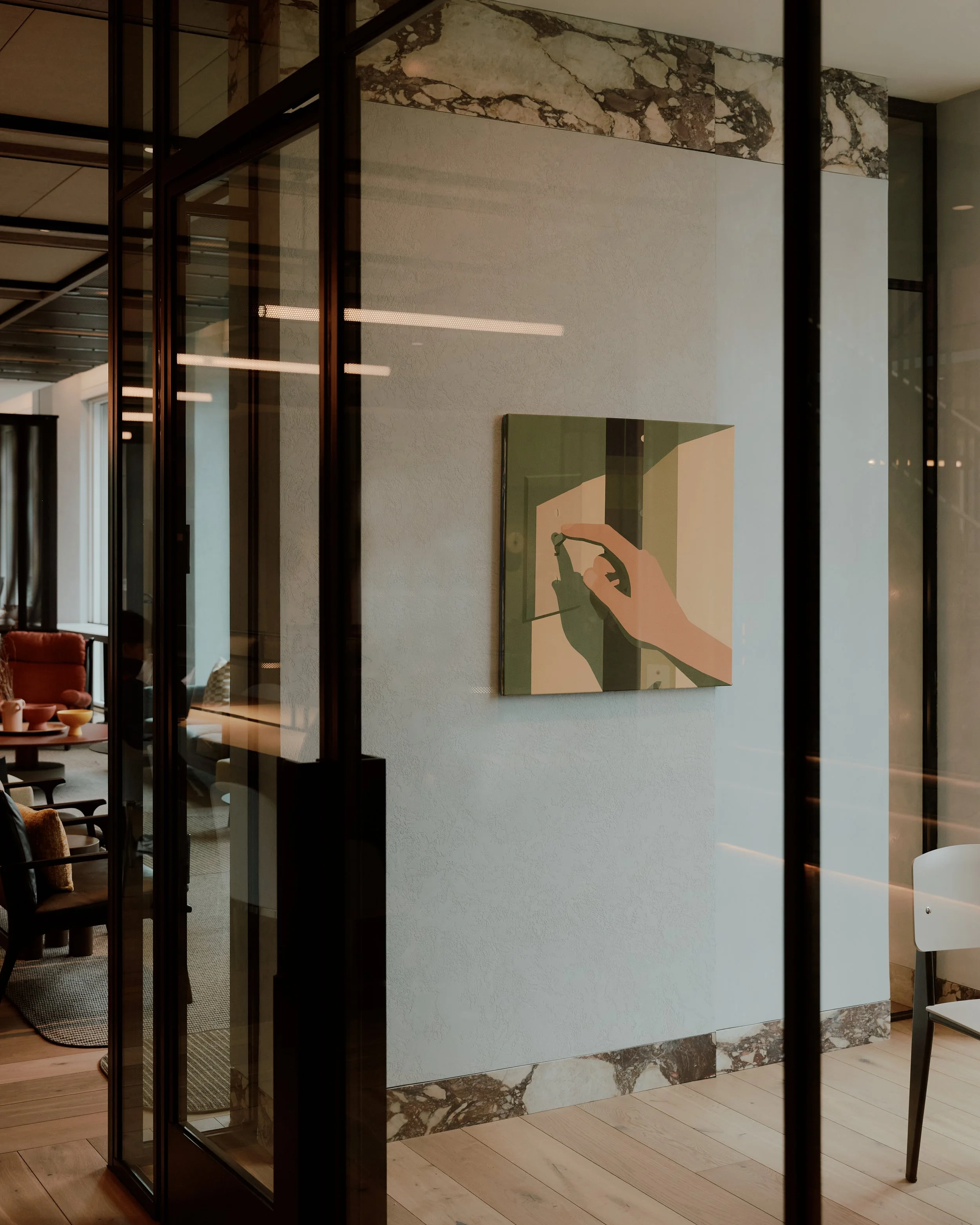 Glass partition and contemporary artwork detail within a resident amenity space at The Suffolk, a Lower East Side residential building, interiors by JG Neukomm Architecture