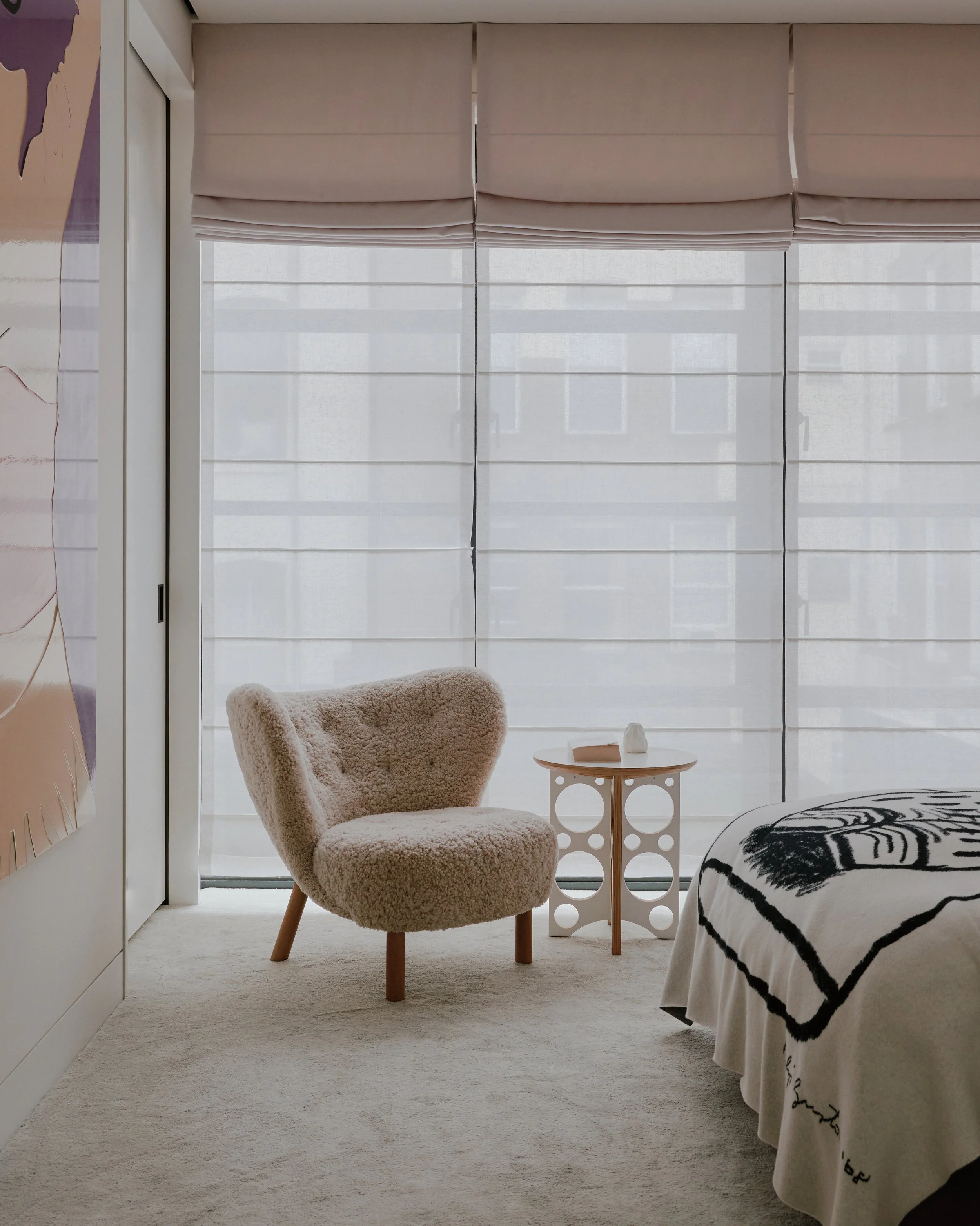 Bedroom reading nook with a sheepskin chair beside a window in a West Village townhouse by JG Neukomm Architecture