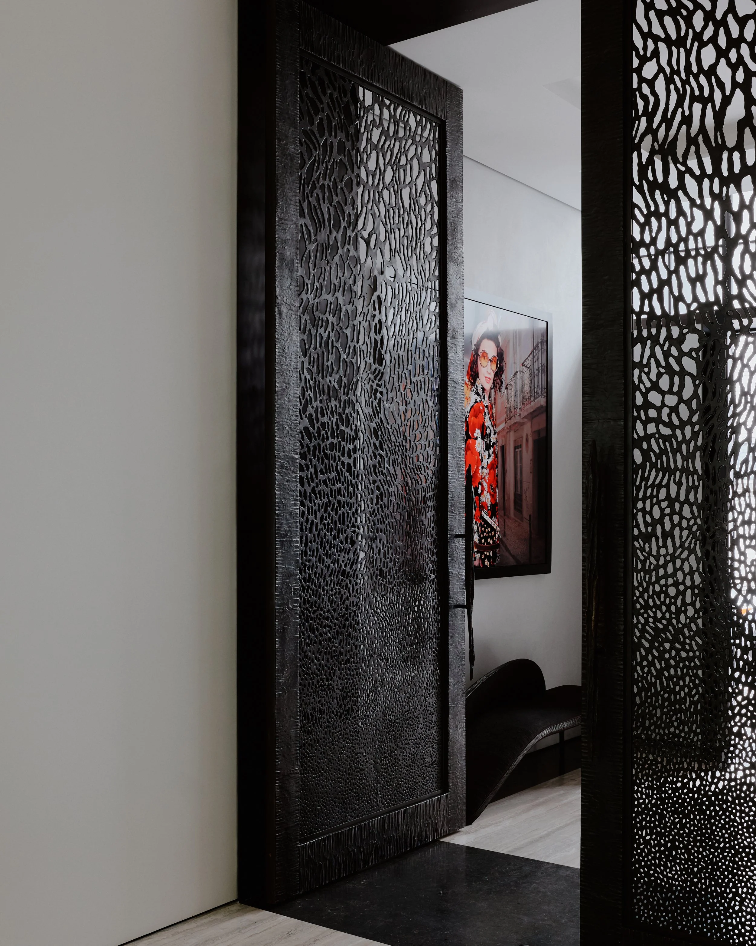 Custom perforated-metal screen framing a view to contemporary art in a West Village townhouse by JG Neukomm Architecture