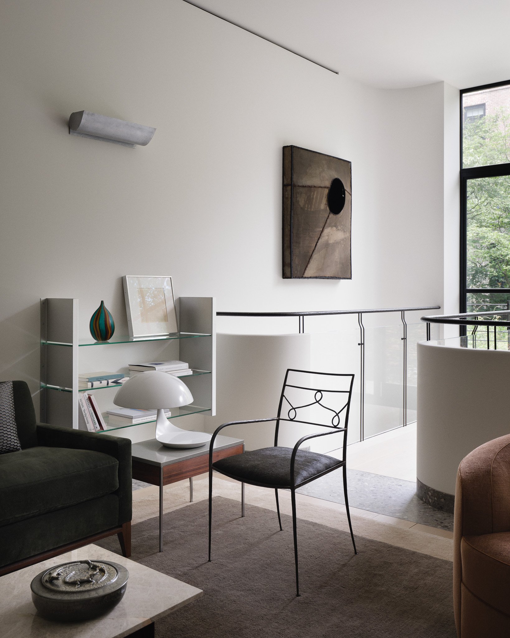 Glass shelving styled with art and design books in a West Village townhouse by JG Neukomm Architecture