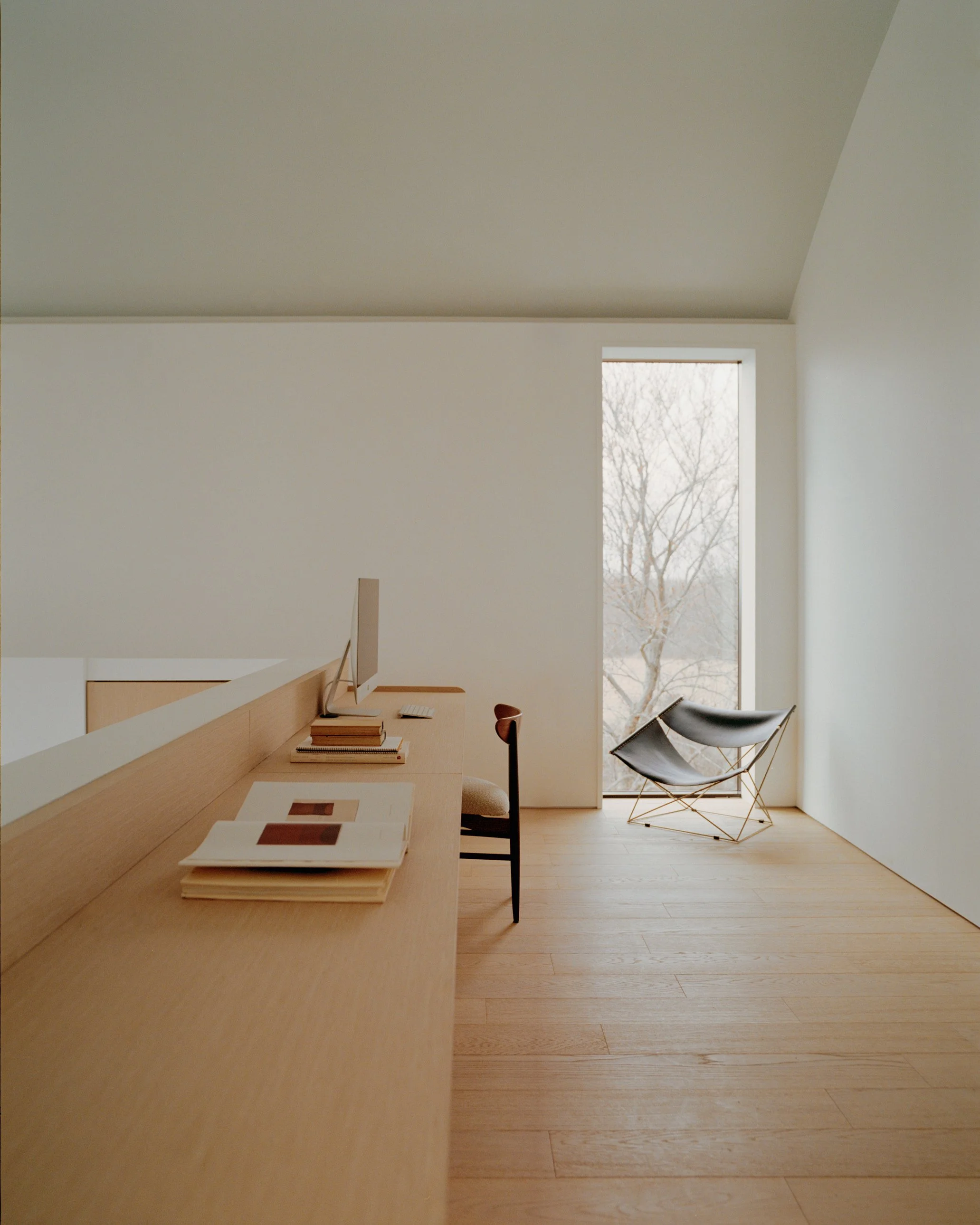 Home office with a built-in wood desk under a barrel vaulted ceiling at a Ghent, NY home by JG Neukomm Architecture