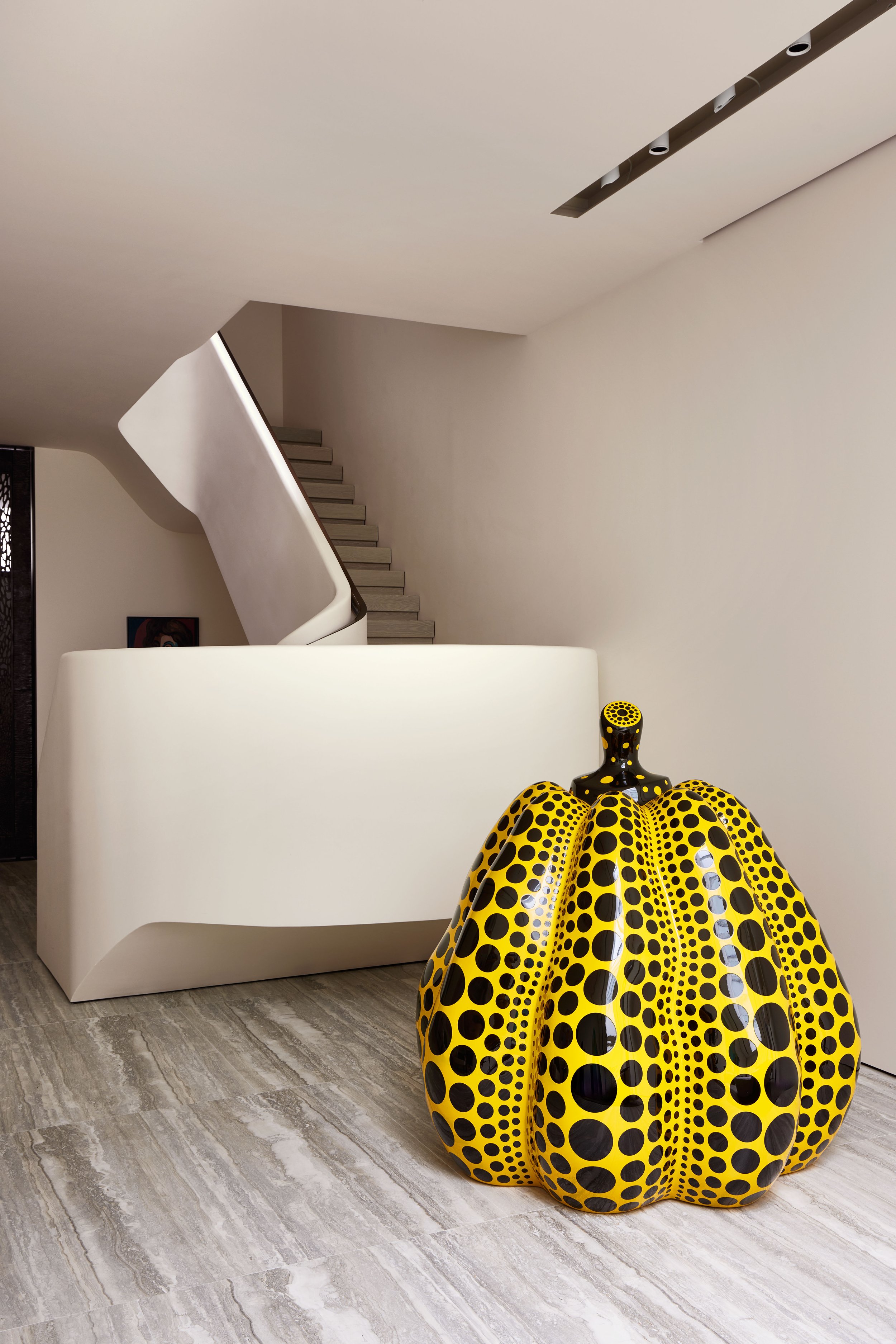 Sculptural white plaster staircase beside a contemporary sculpture in a West Village townhouse by JG Neukomm Architecture
