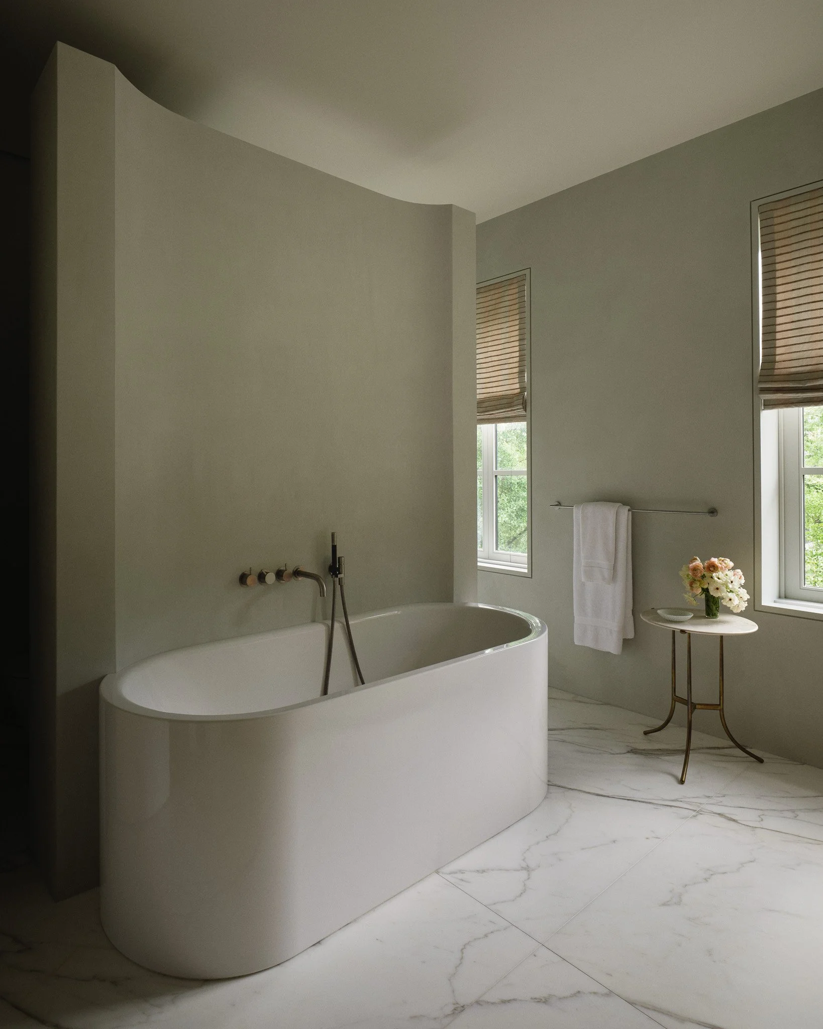 Primary bathroom with a freestanding tub and marble flooring in a West Village townhouse by JG Neukomm Architecture