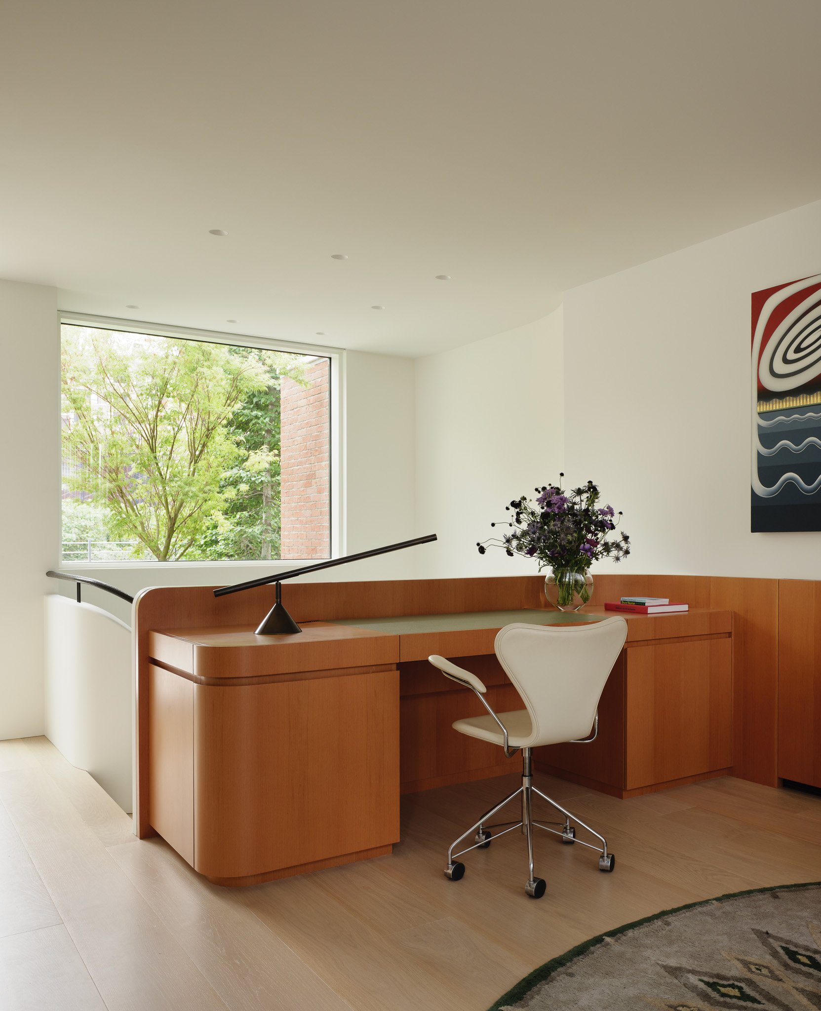 Home office with a custom built-in wood desk in a West Village townhouse by JG Neukomm Architecture